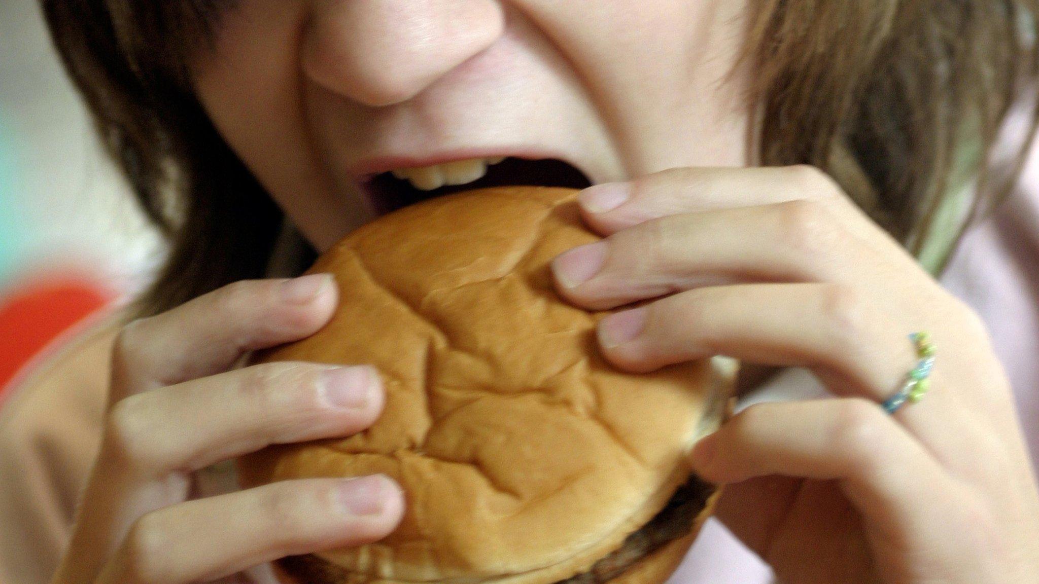 girl eating a burger