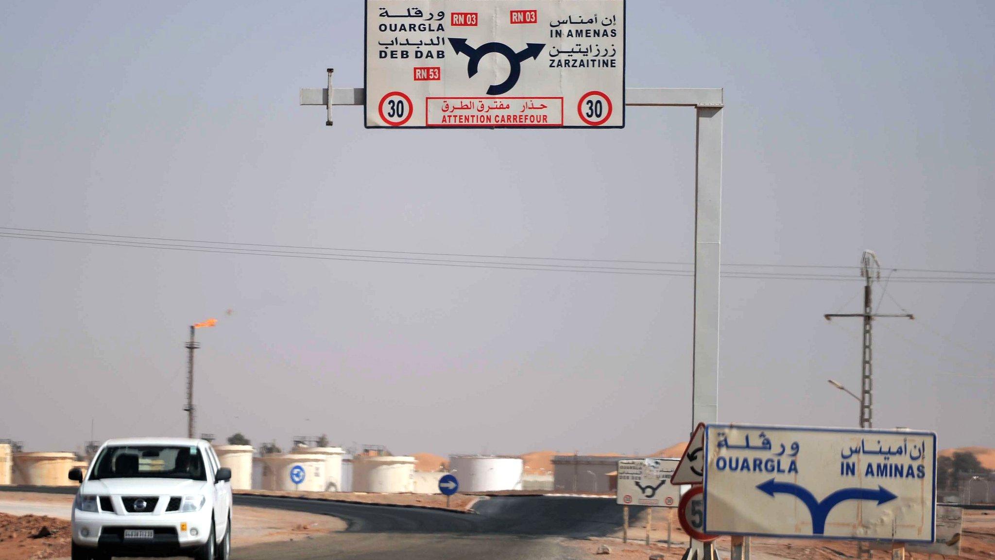 A car drives past the gas plant on the outskirts of In Amenas, in Algeria, where militants took dozens of foreign workers hostage (18 January 2013).