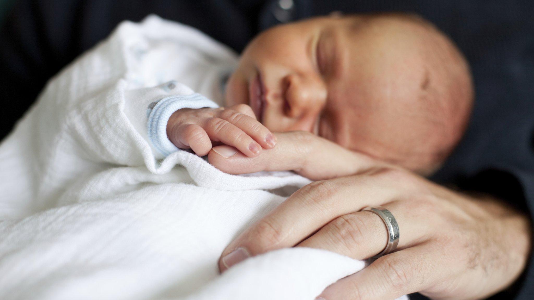 Newborn in father's arms