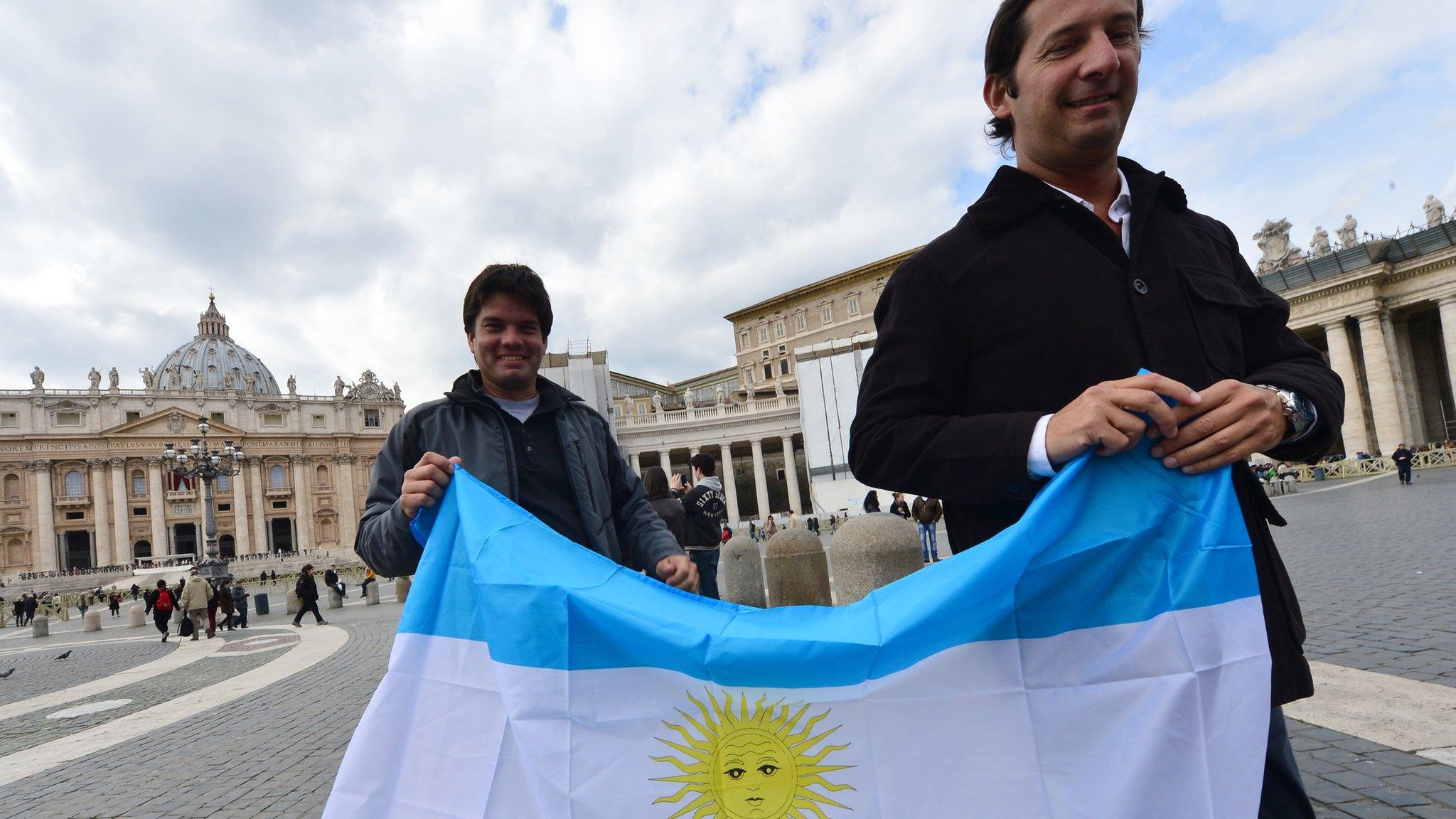 Two men brandish the Argentine flag on St Peter's Square, Rome, 15 March