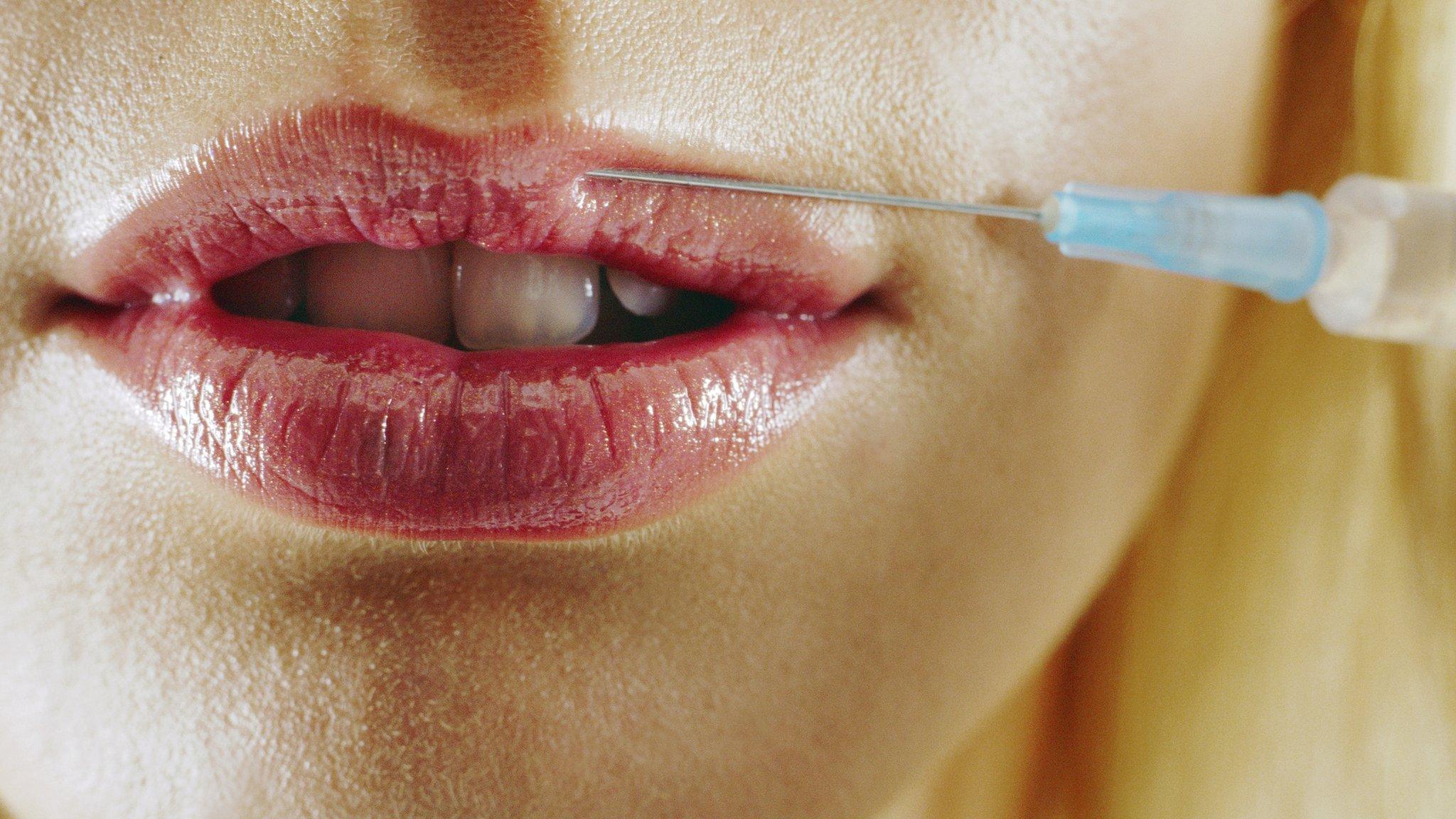 Woman's lips being injected