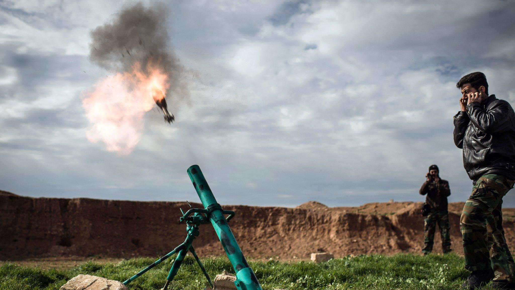 Syrian rebels fire a mortar in Al-Bab, 30km from the Syrian city of Aleppo on 14 February 2013