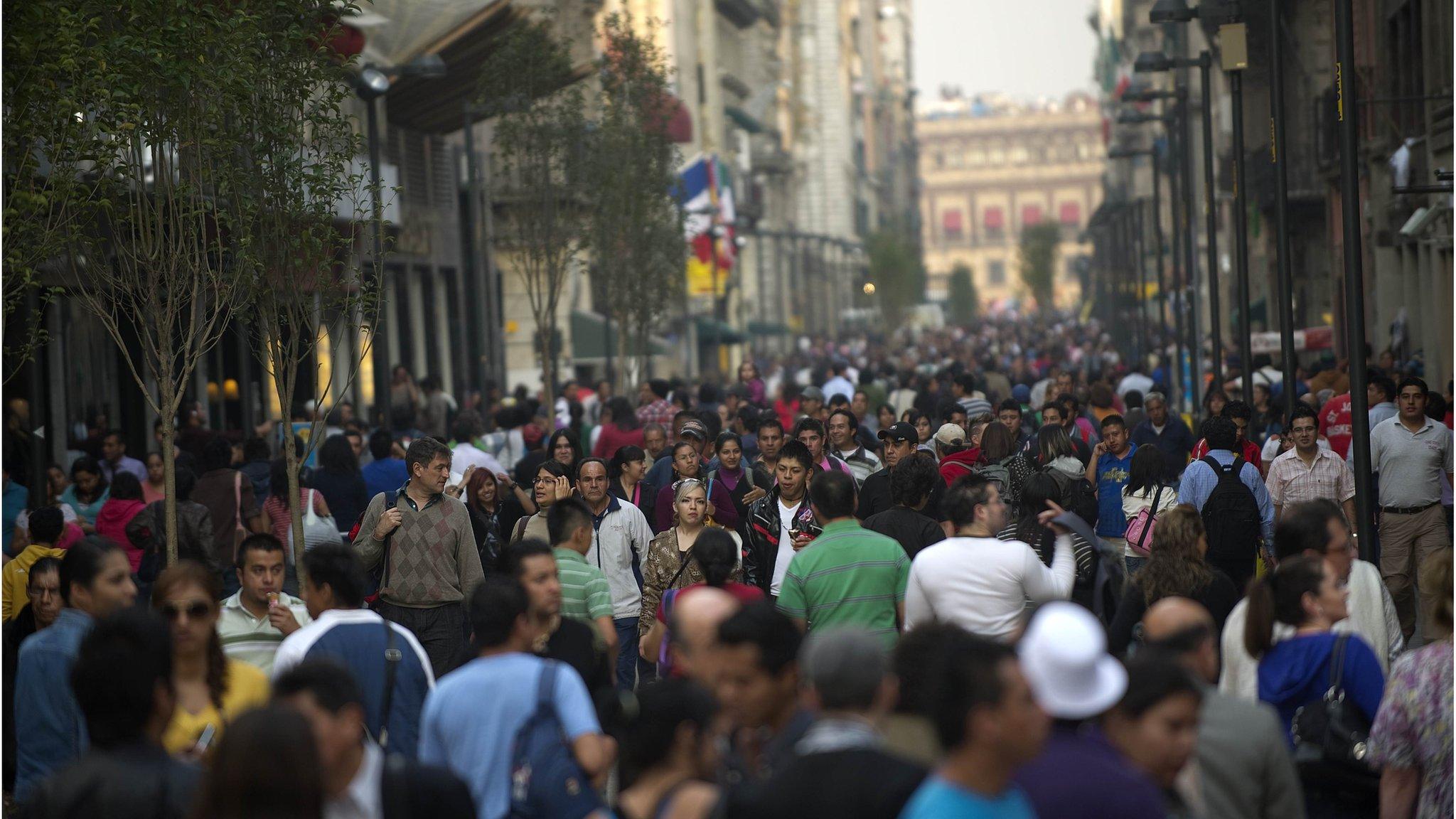 People walk on a crowded street in Mexico city