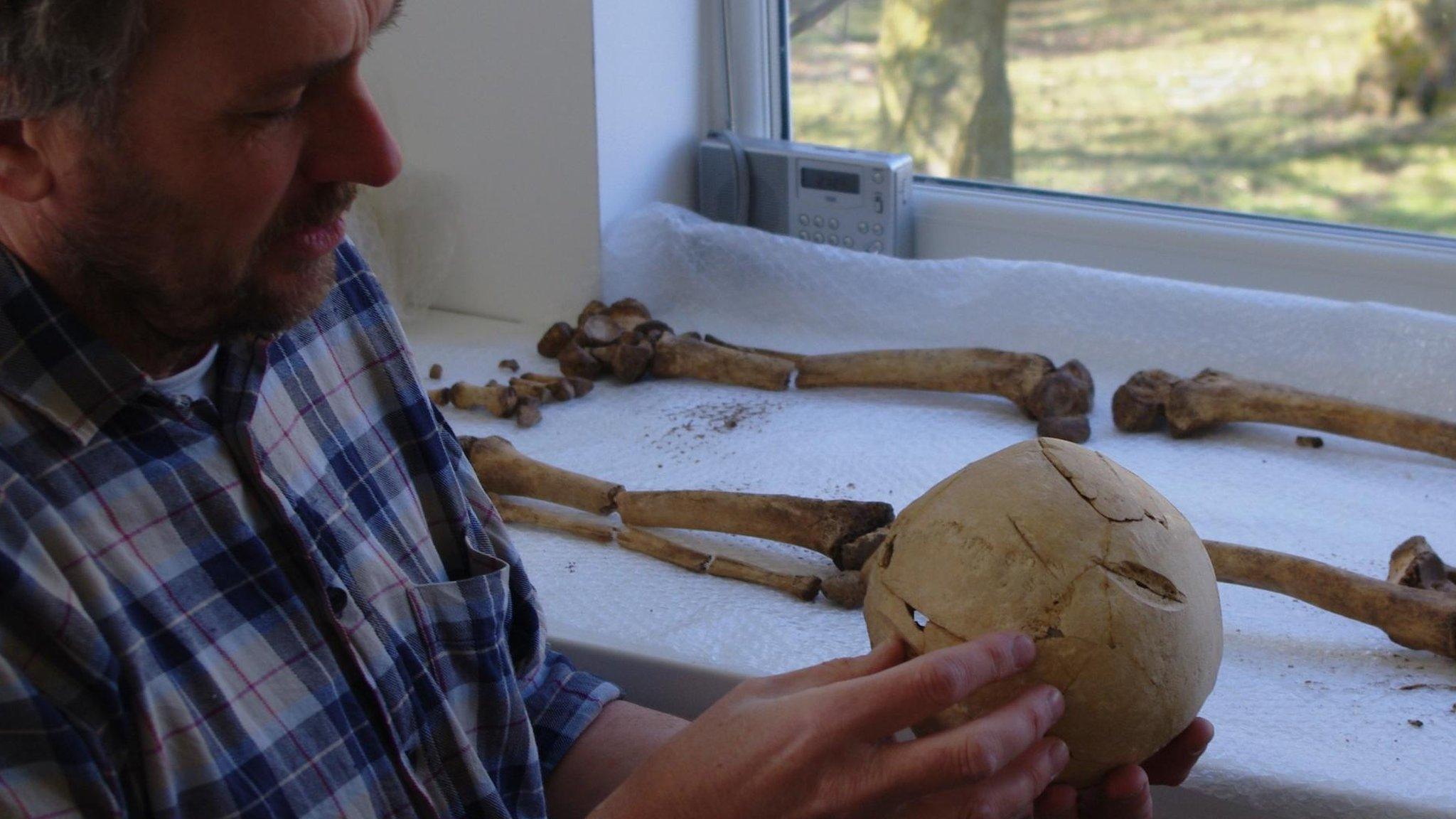 Tim Sutherland examining the skull