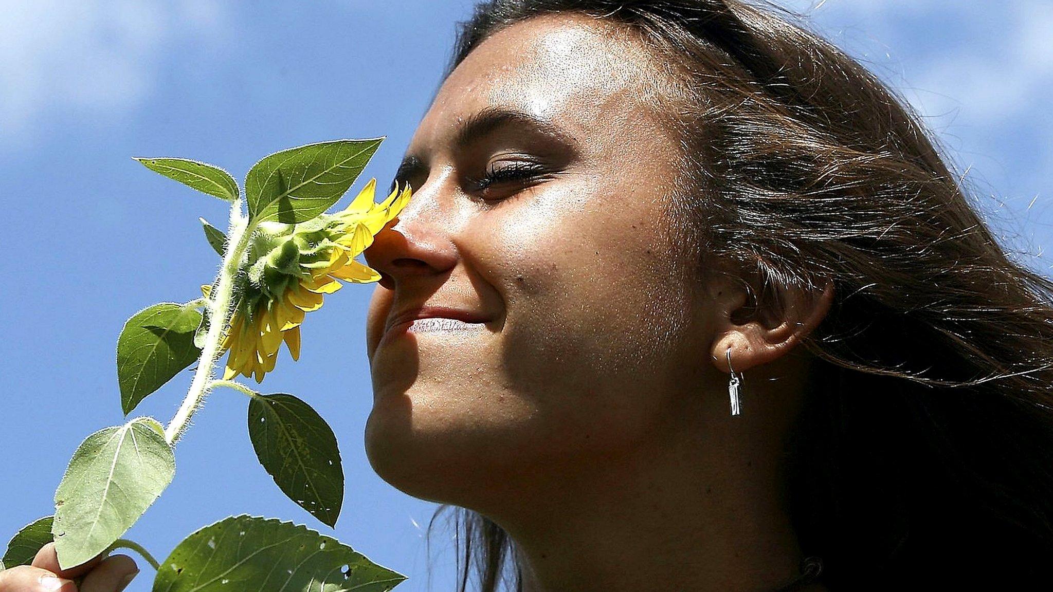 Woman smells flower