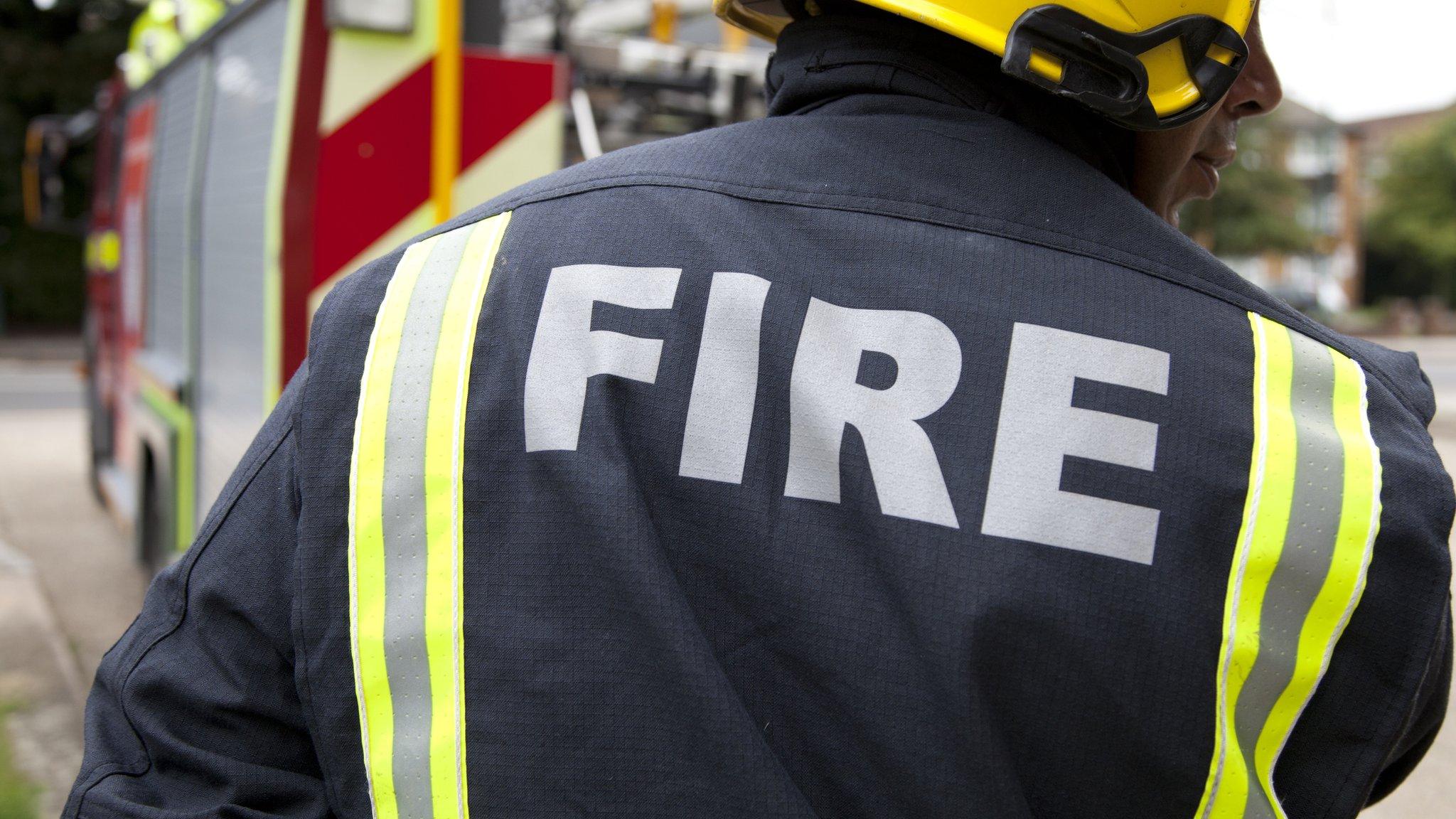 Fireman in front of fire truck