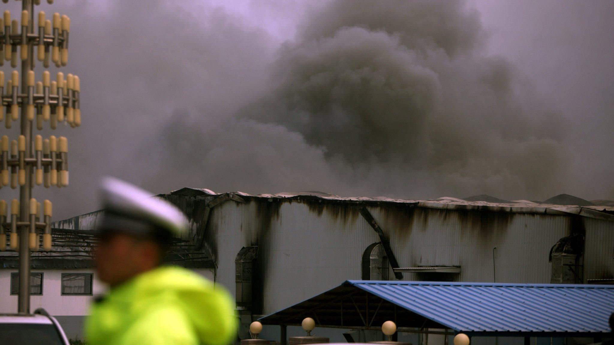 Smoke rises from Baoyuan poultry plant that caught fire at Dehui, north-east China's Jilin province on Monday