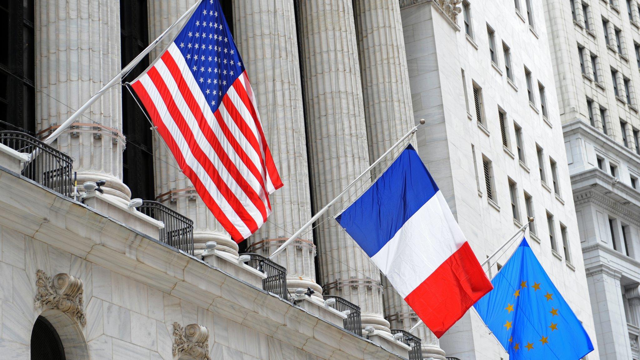 US, French and EU flags at the New York Stock Exchange