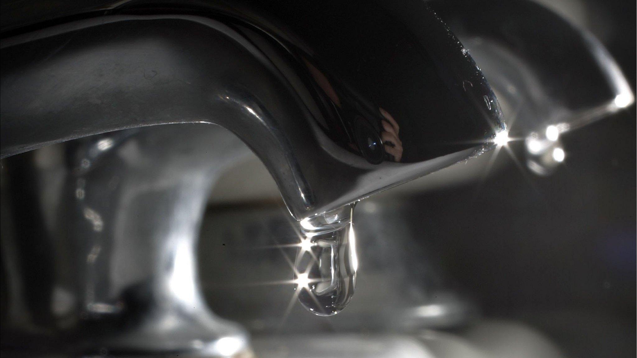 Water drips from a tap