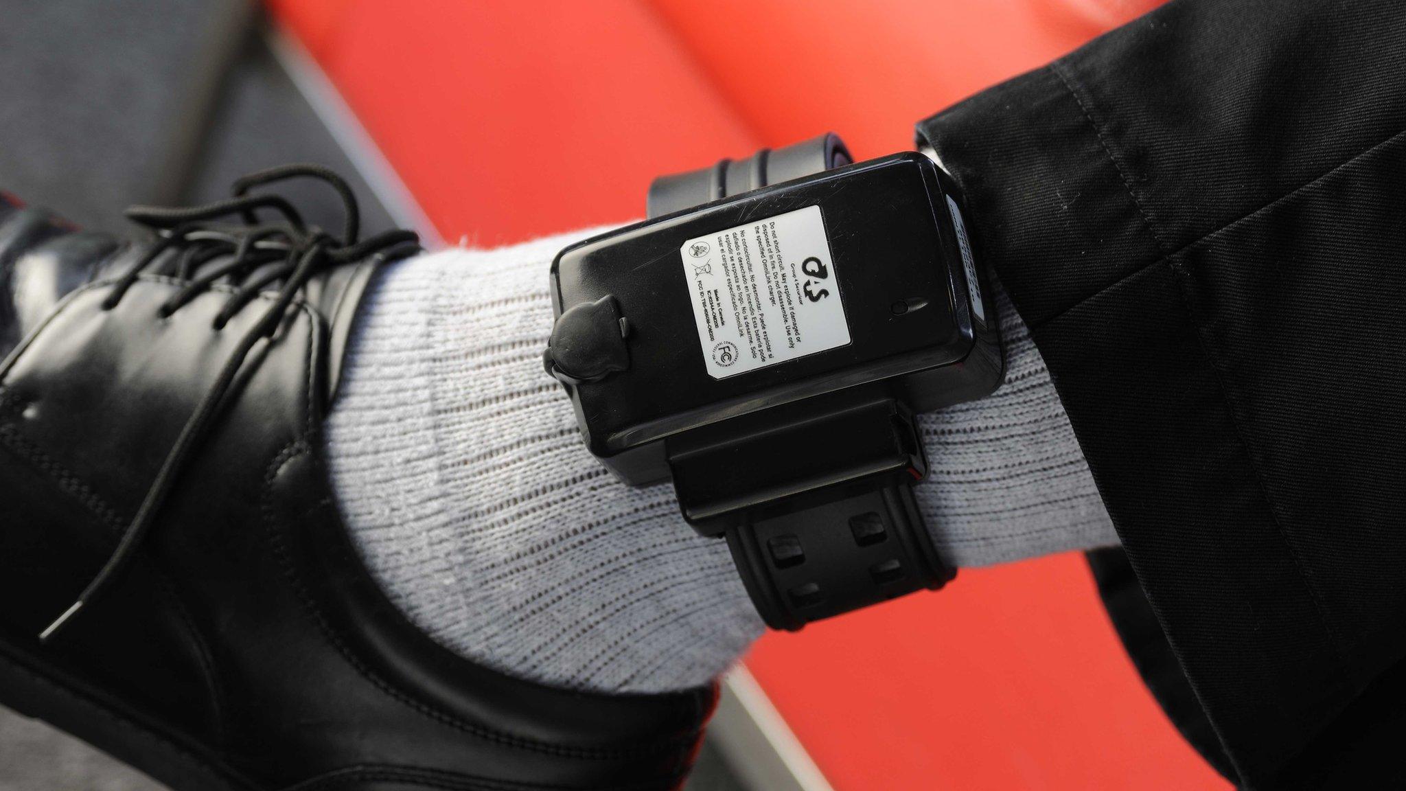 Electronic tag on man's leg