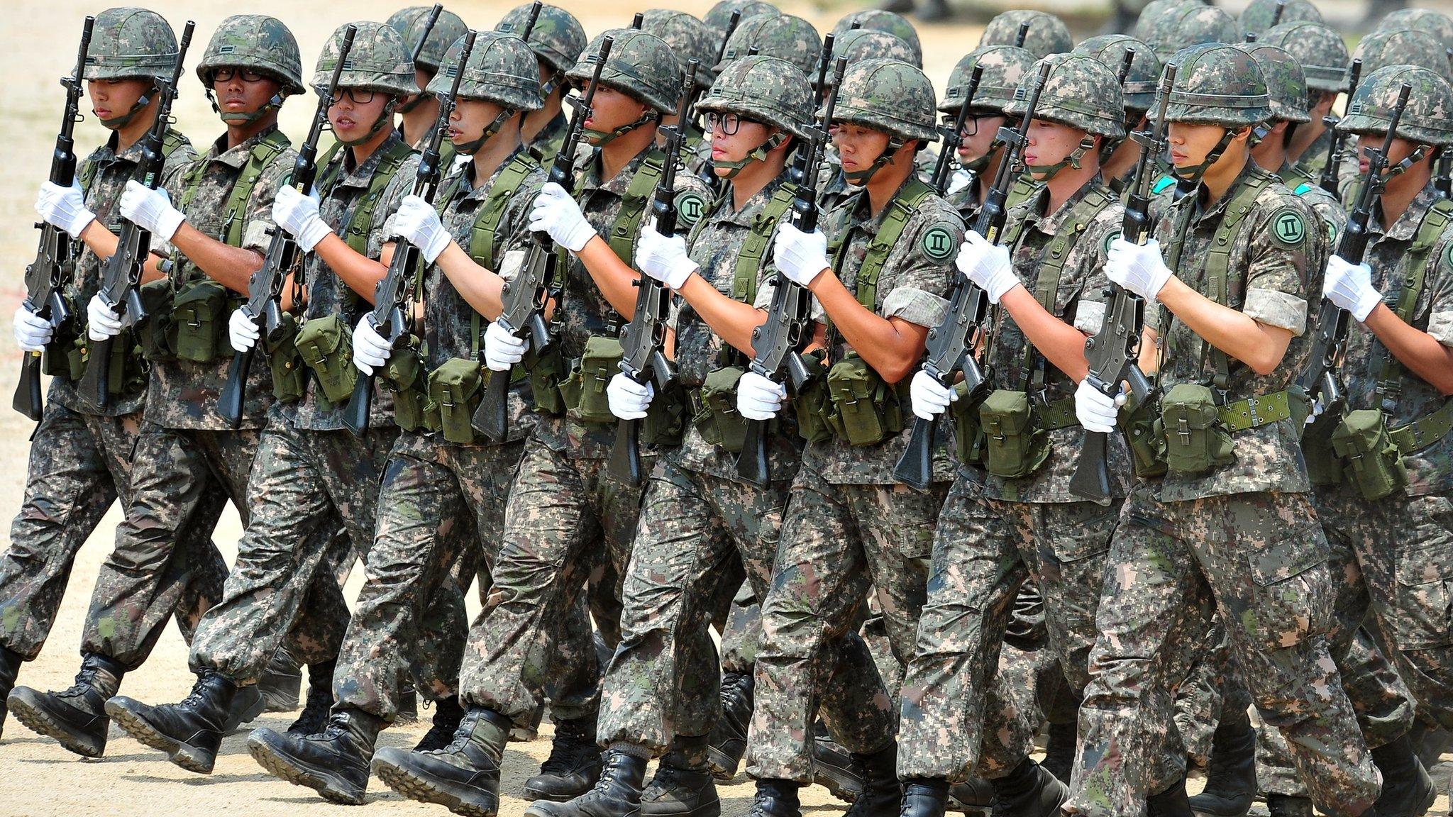 South Korean soldiers march during a ceremony for a re-enactment of the battle of Chuncheon at the beginning of the Korean War