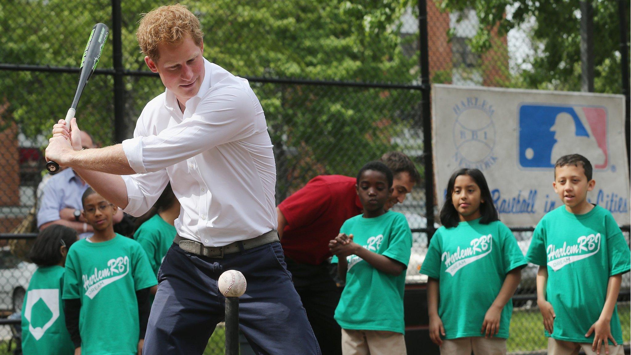 Prince Harry watches a baseball go by