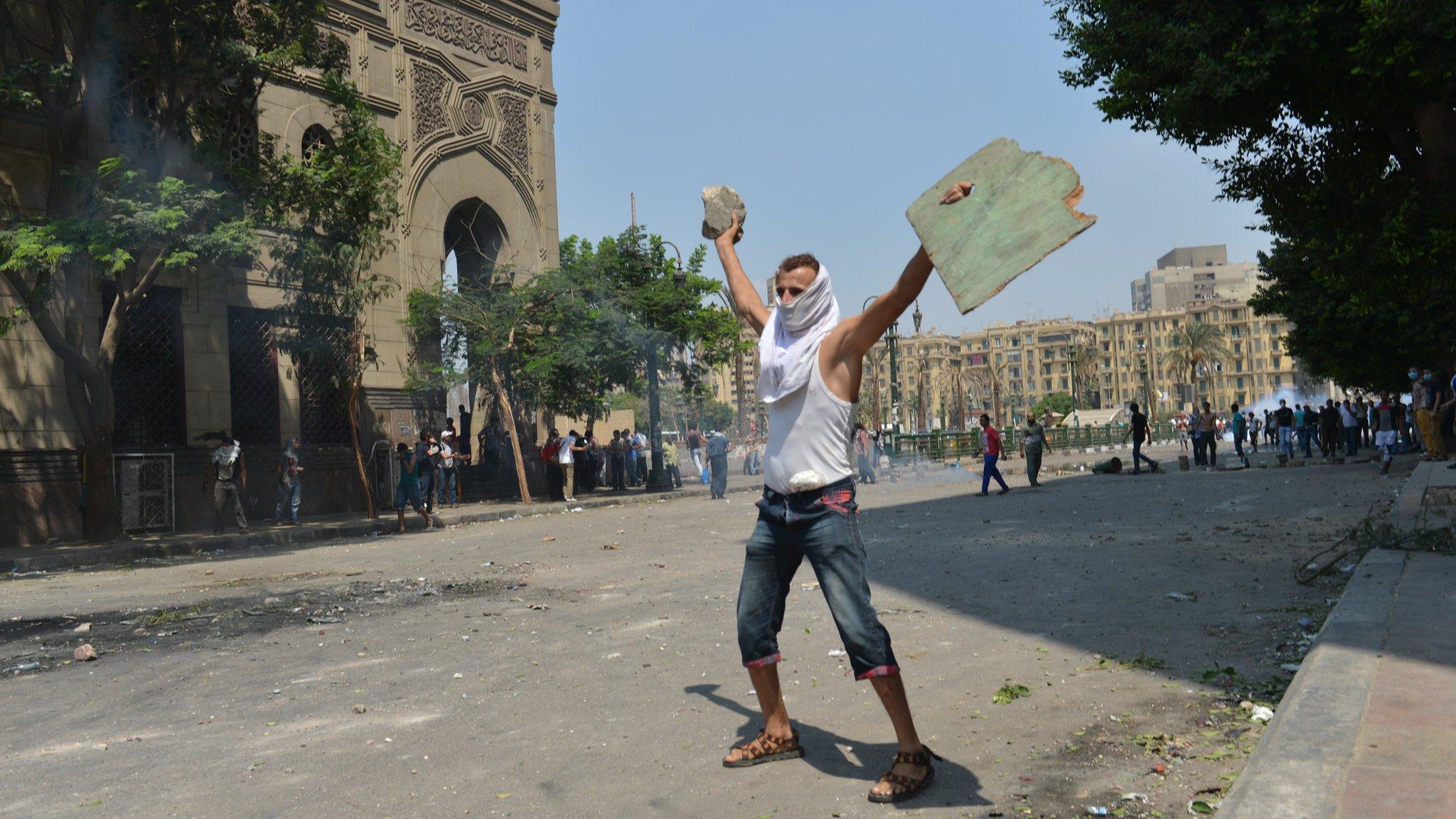 A protester stands on the street near the US embassy in Cairo, Egypt on 1 August 2013