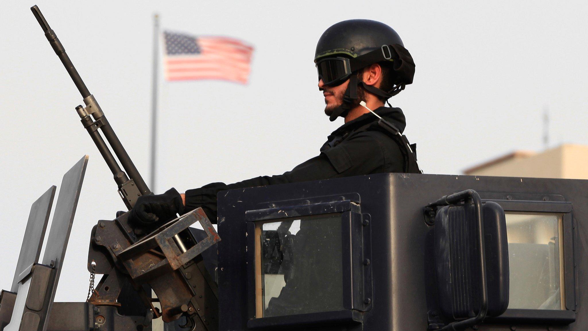 A Bahraini soldier in an armoured personnel vehicle outside the US embassy in Manama, Bahrain, on 4 August 2013