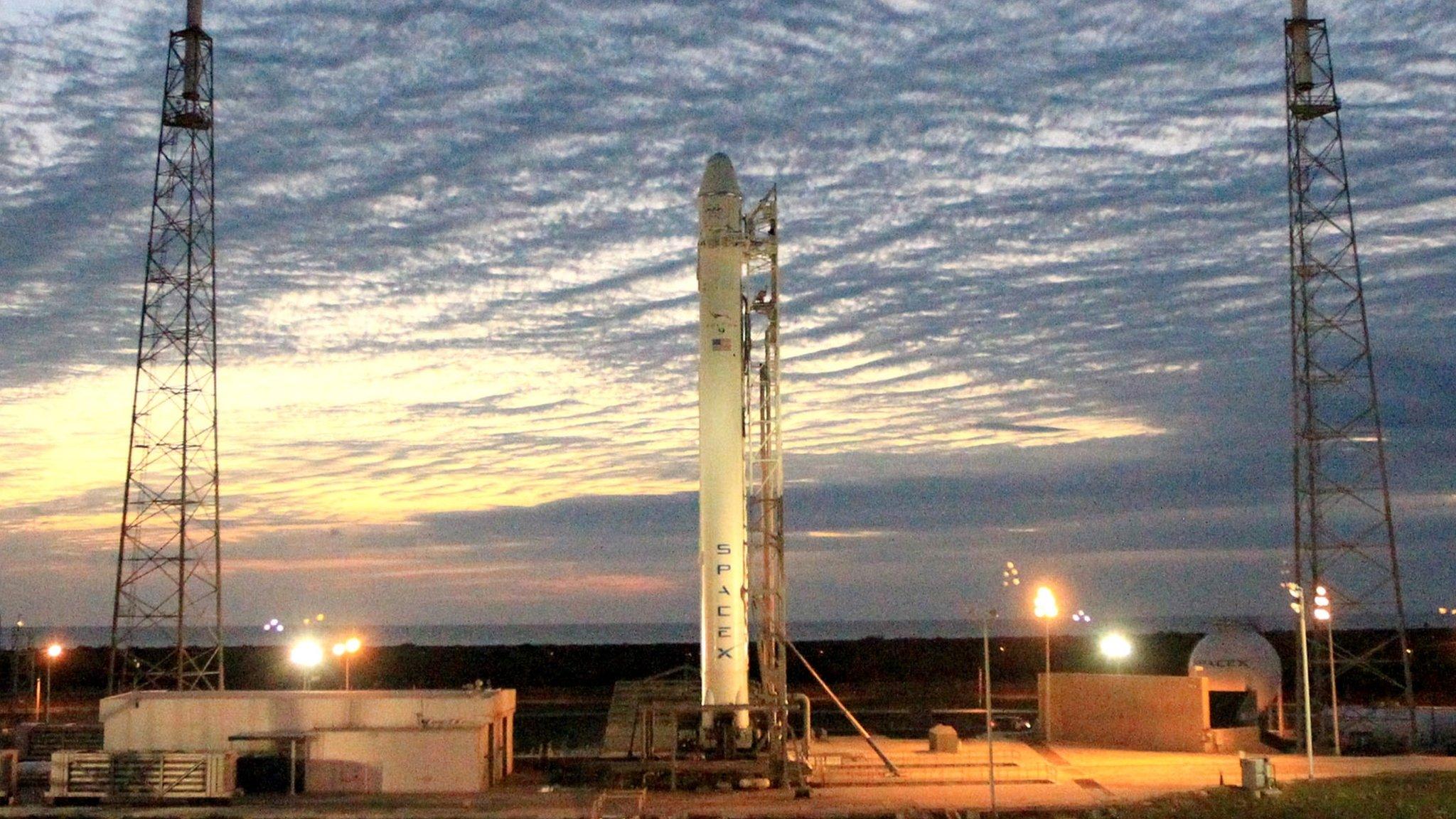 Sun rises over SpaceX's launch pad, and a Falcon 9 rocket and a Dragon spacecraft ready to go to the International Space Station