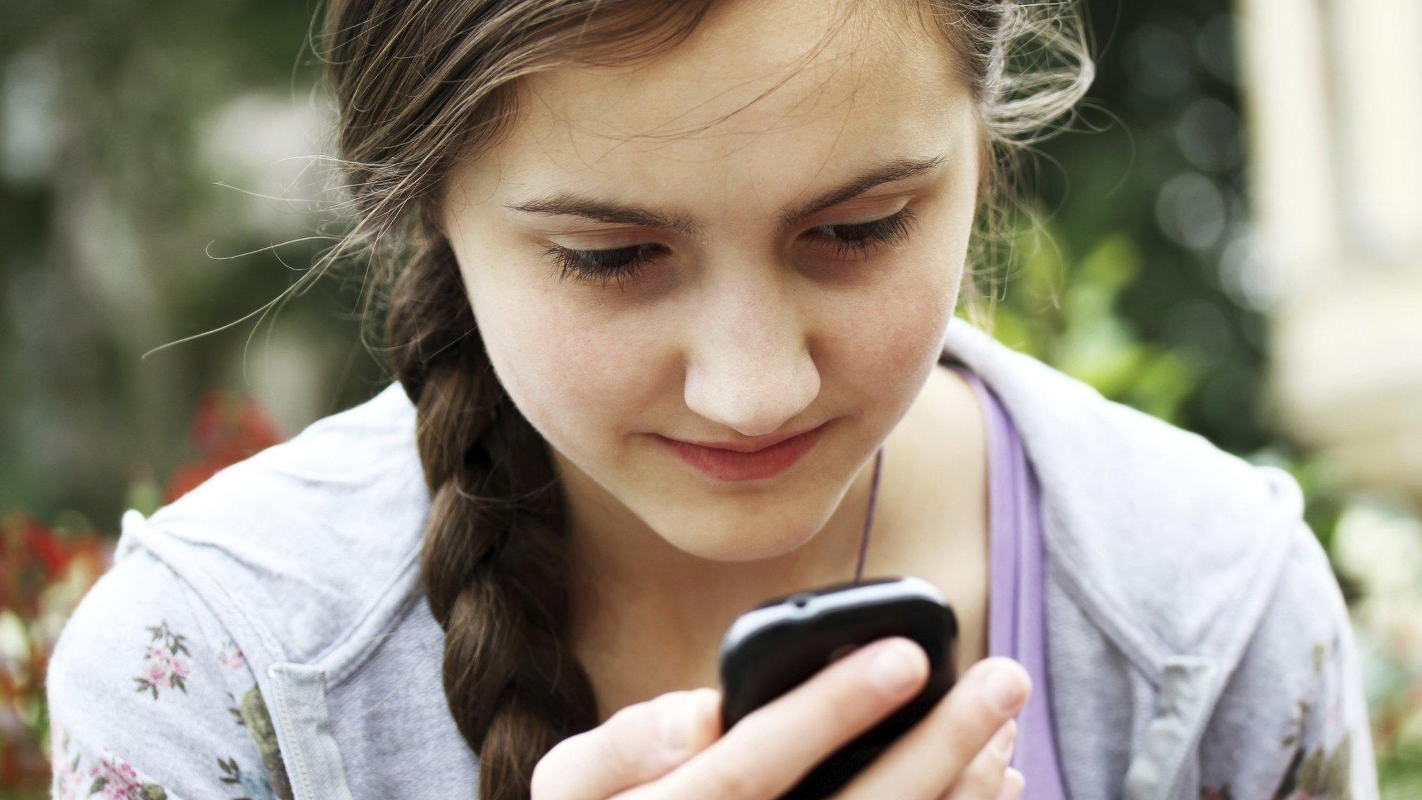 Young girl using mobile - posed by model