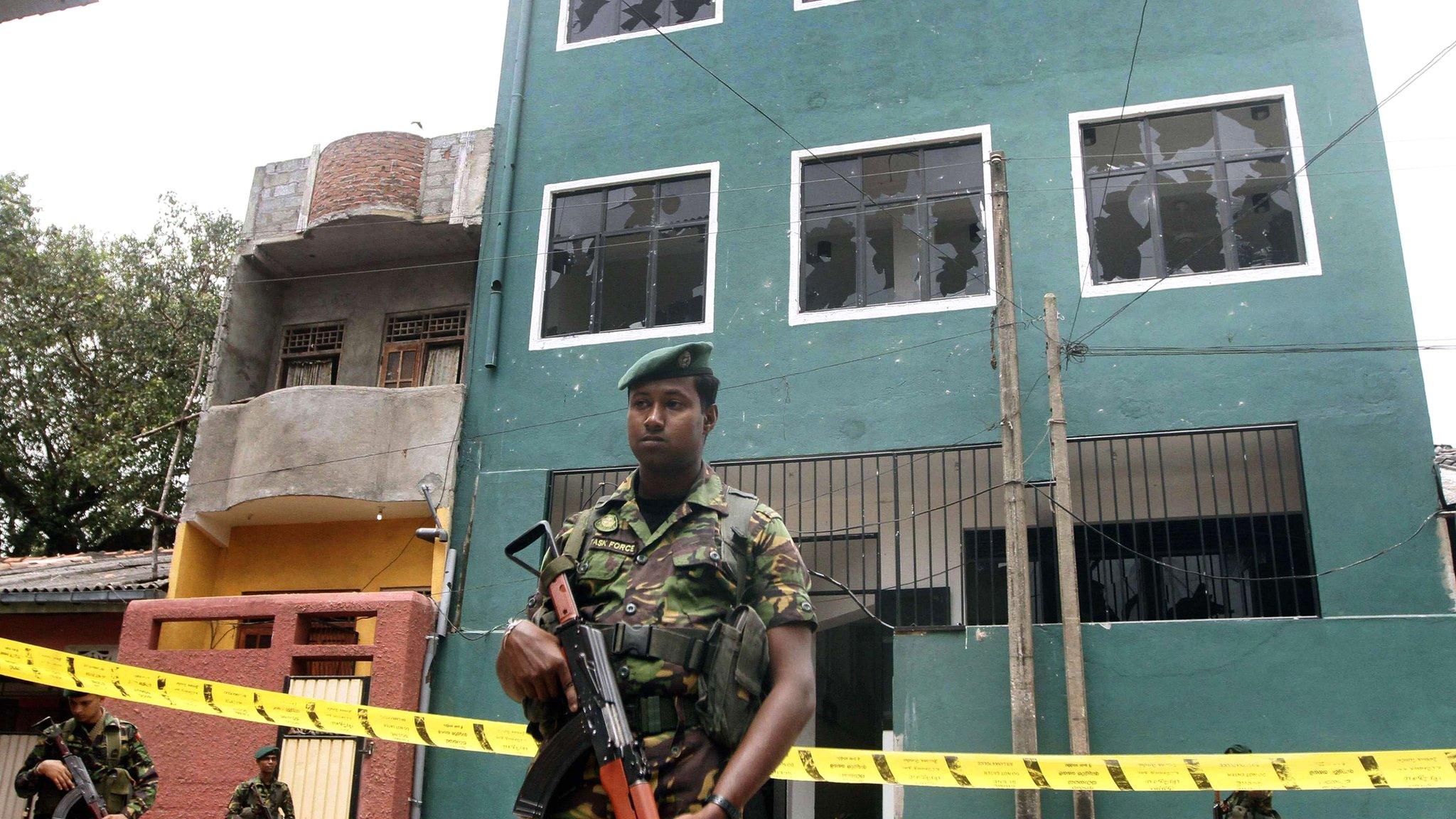 Special Task Force commandos stand guard outside a vandalised mosque in Colombo on 11 August 2013