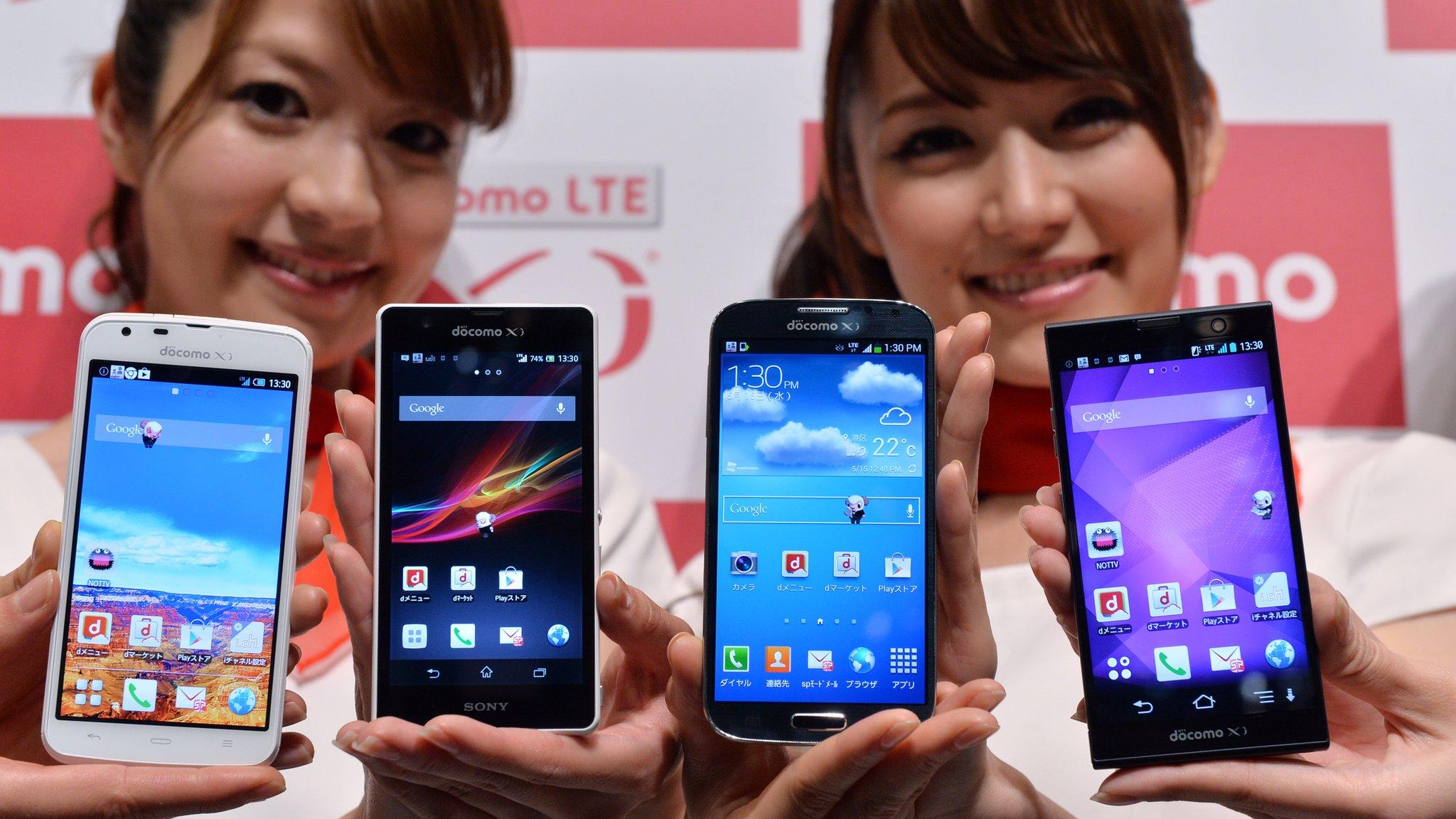 Models display various smartphones