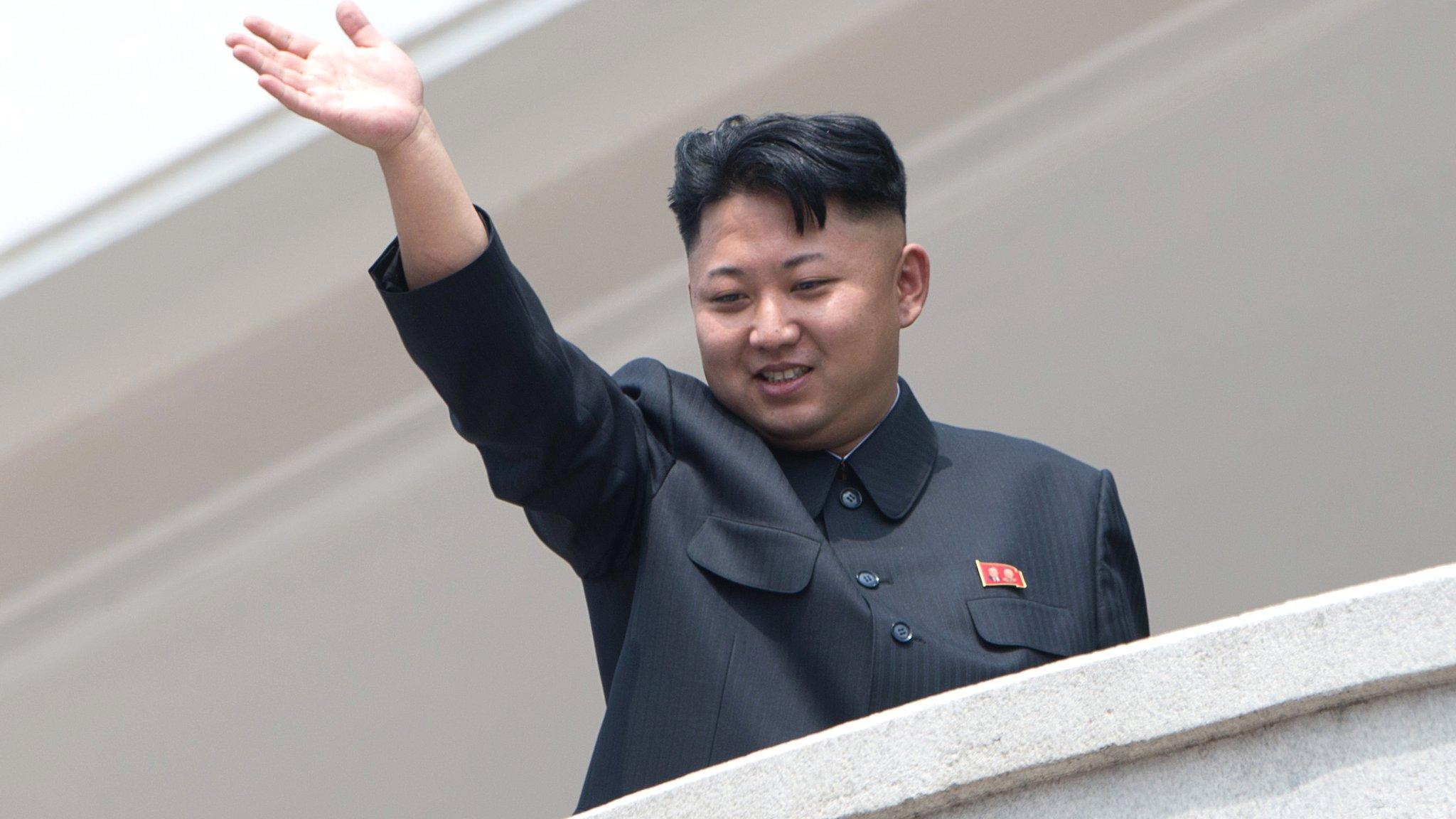 Kim Jong-un waves from a balcony