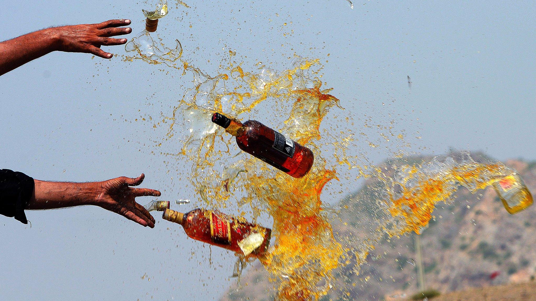 Pakistani Frontier Corps (FC) personal brake liquor bottles in a ceremony in the Shahkas area of the Jamrud Khyber Agency, one of the Federally Administered Tribal Areas, on 26 June 2013. Officials destroyed the contraband as part of International Anti-drug Day.