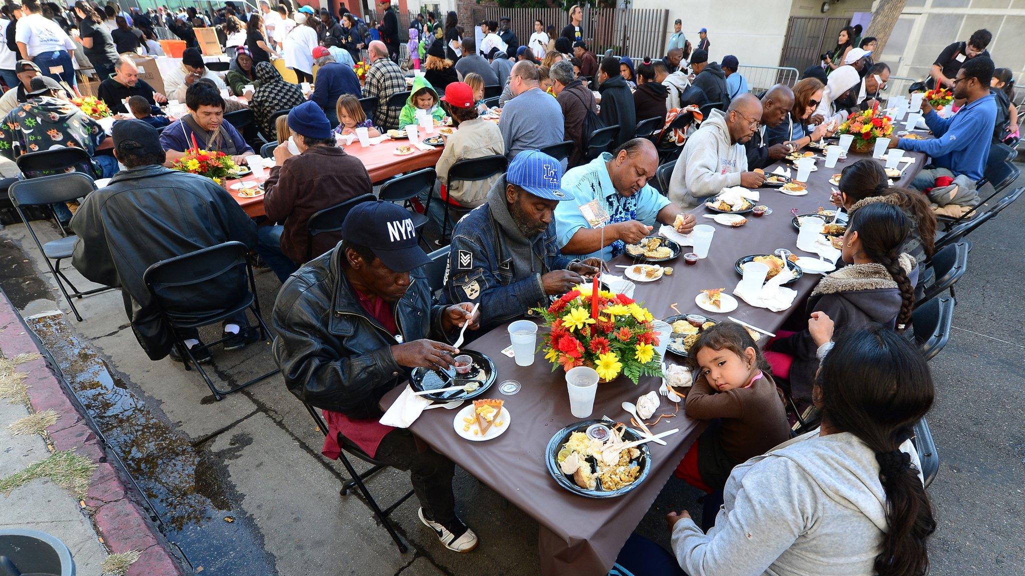 Homeless and poor Americans eat lunch at the LA Mission's annual Thanksgiving meal