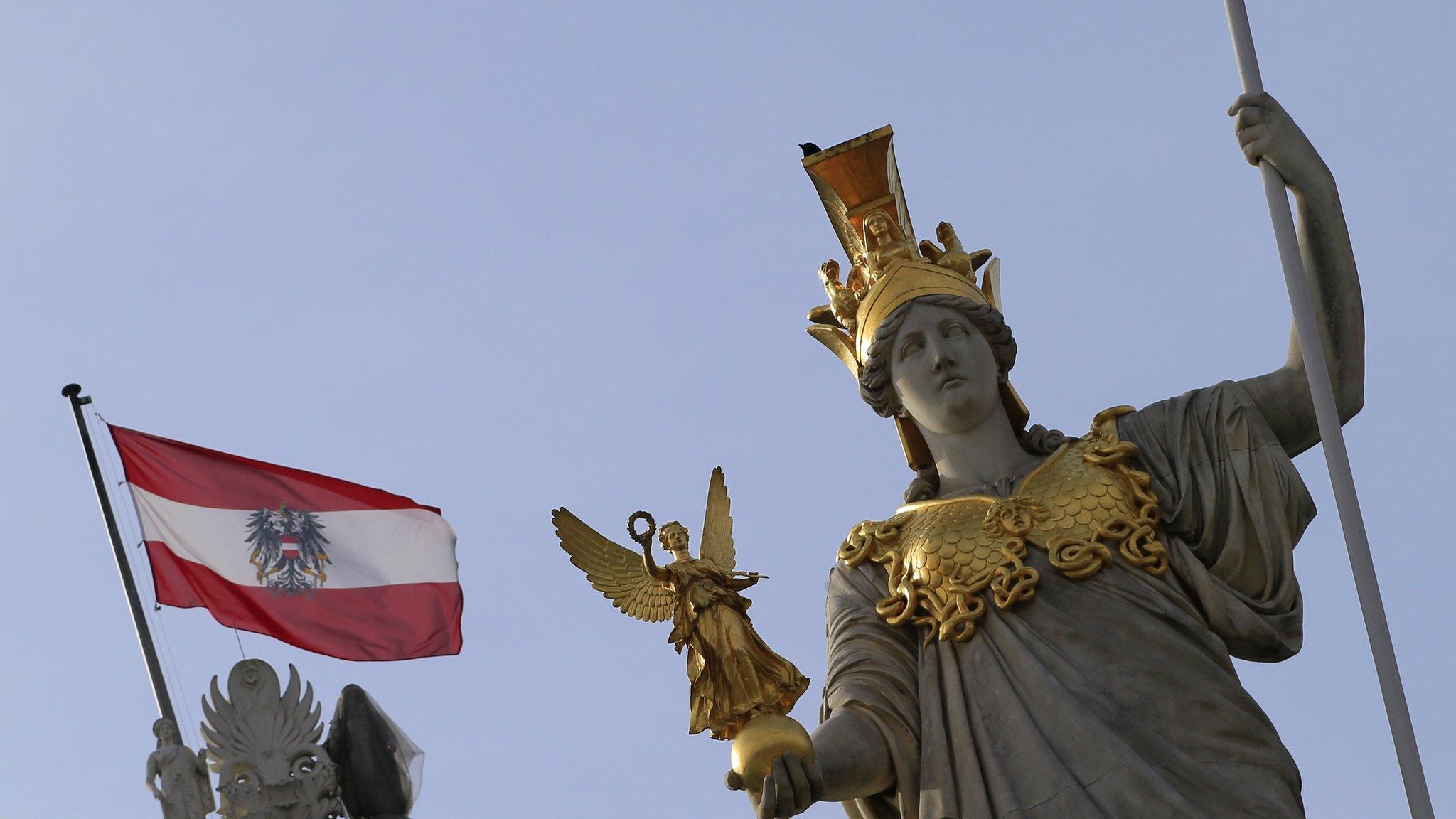 Austria's national flag flies over the parliament building in Vienna