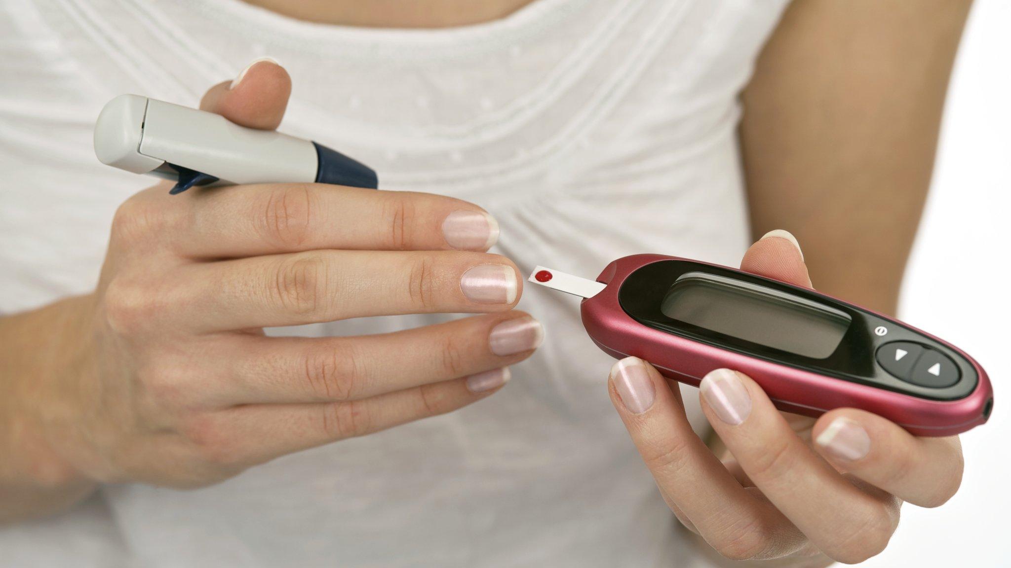 Woman testing blood sugar levels