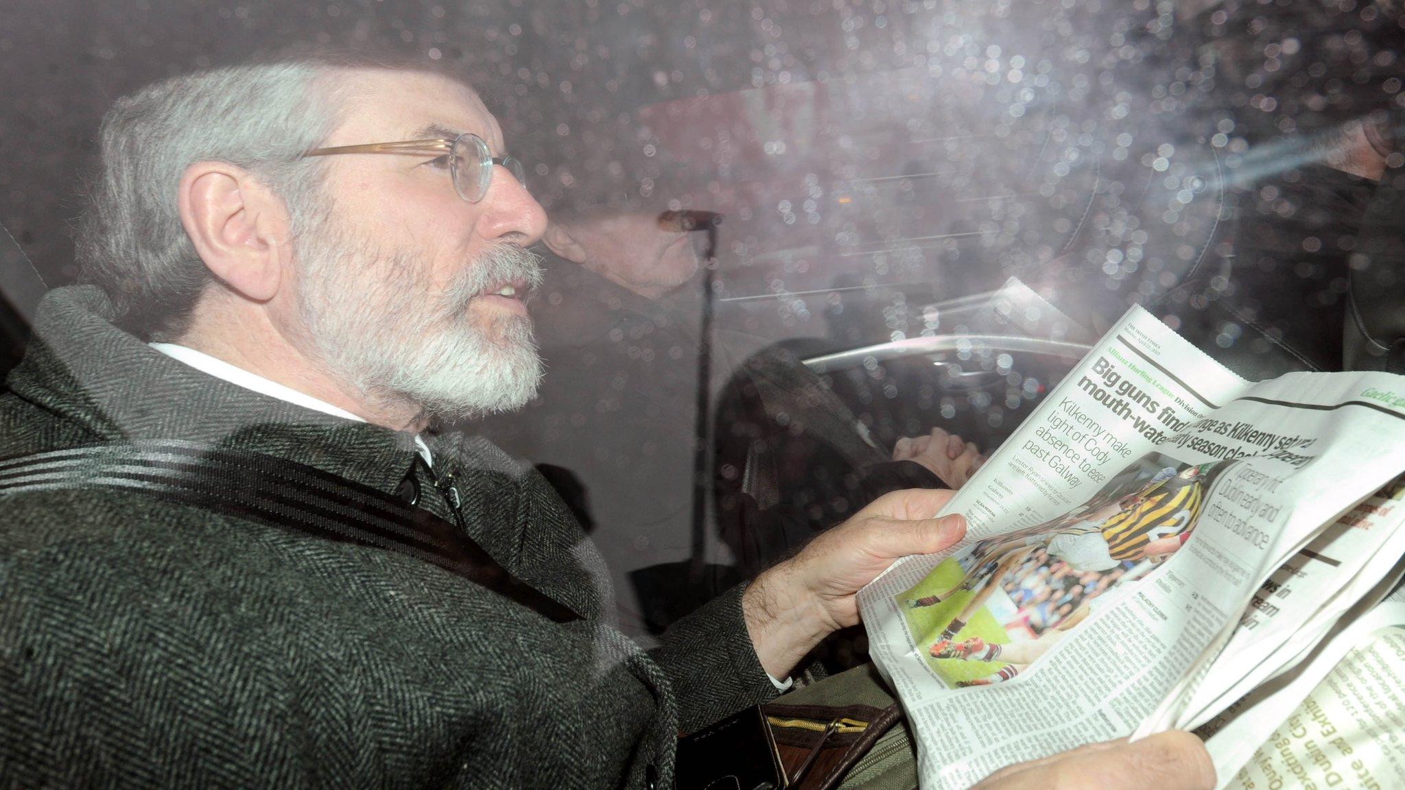 Gerry Adams reading newspaper in back of car