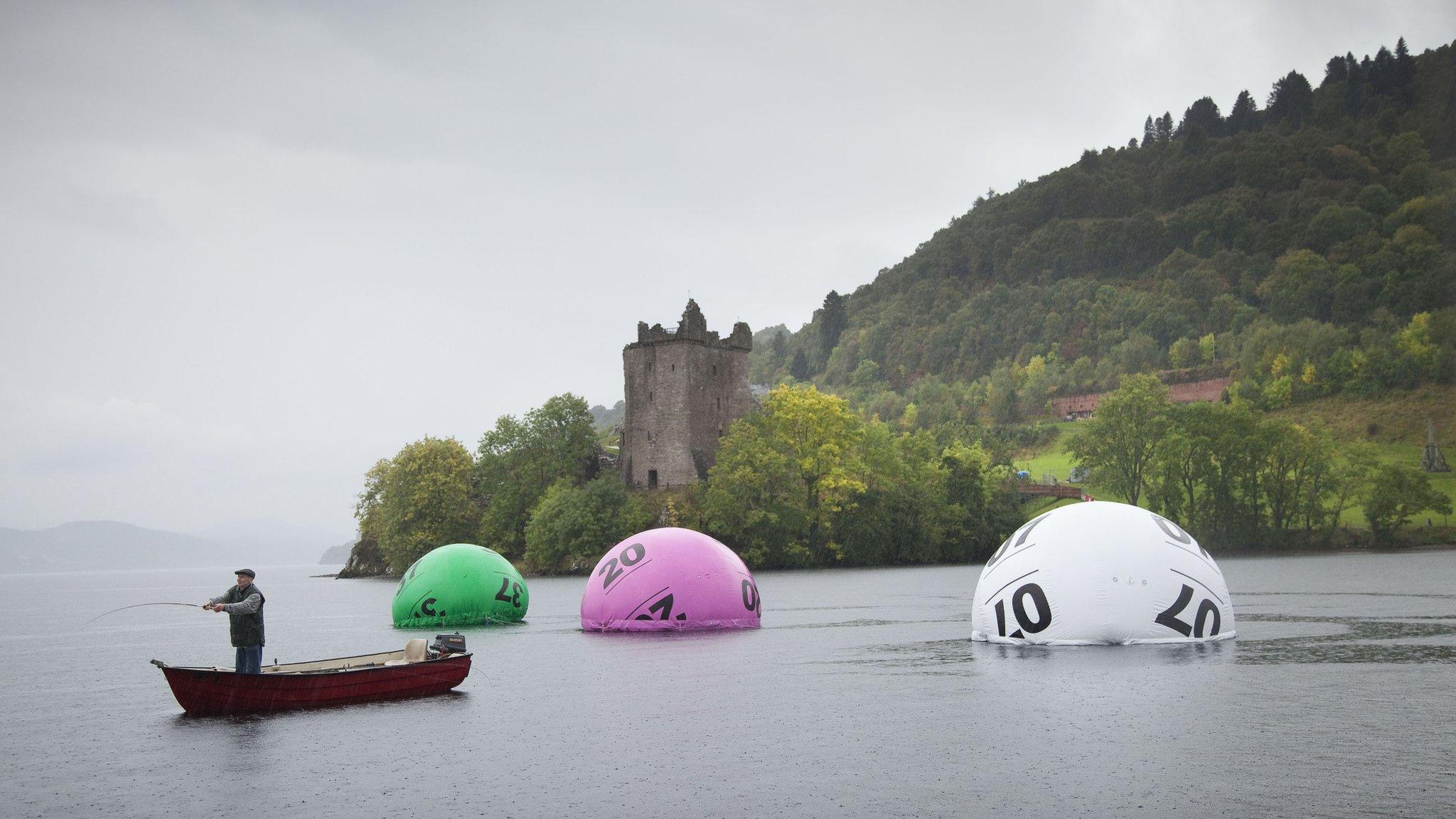 Giant lottery balls in water for publicity photograph