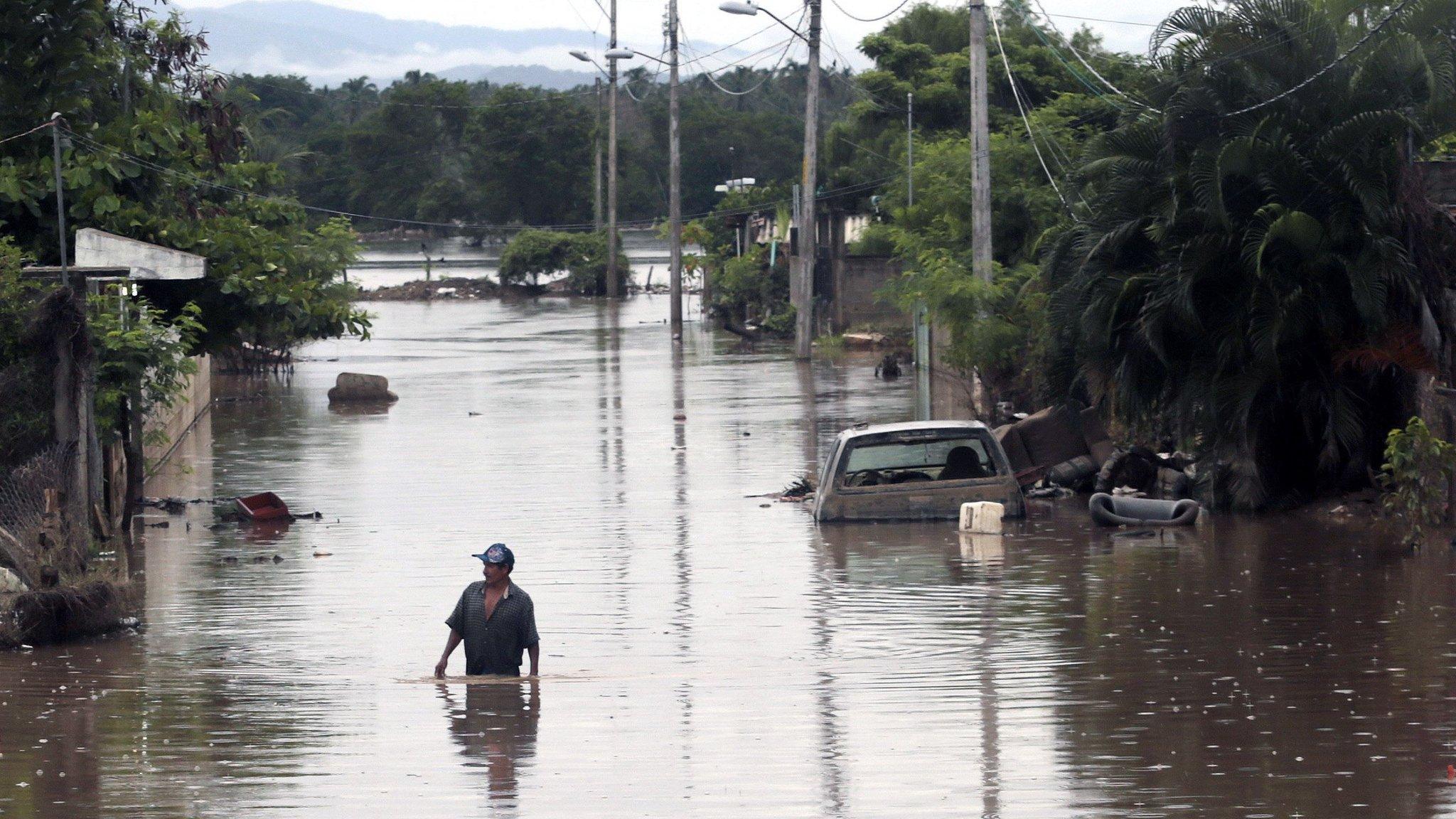 View of a flooded street in Acapulco, Guerrero state, Mexico, on September 26, 2013