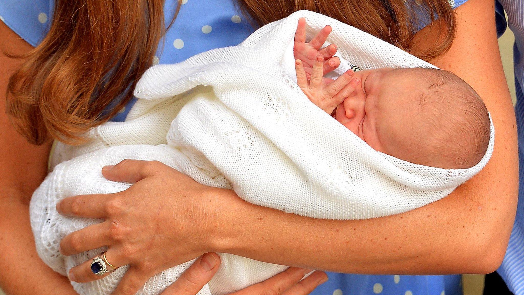Prince George being held by the Duchess of Cambridge outside the Lindo Wing of St Mary's hospital on 23 July 2013