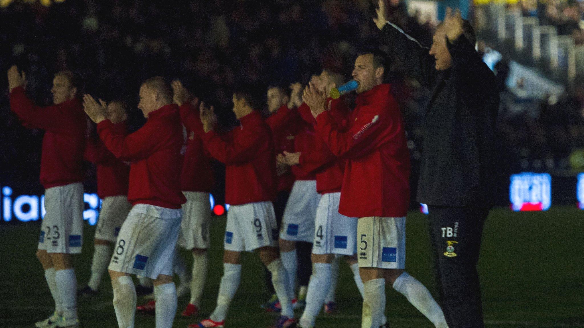 Inverness boss Terry Butcher and his players salute their travelling fans in darkness