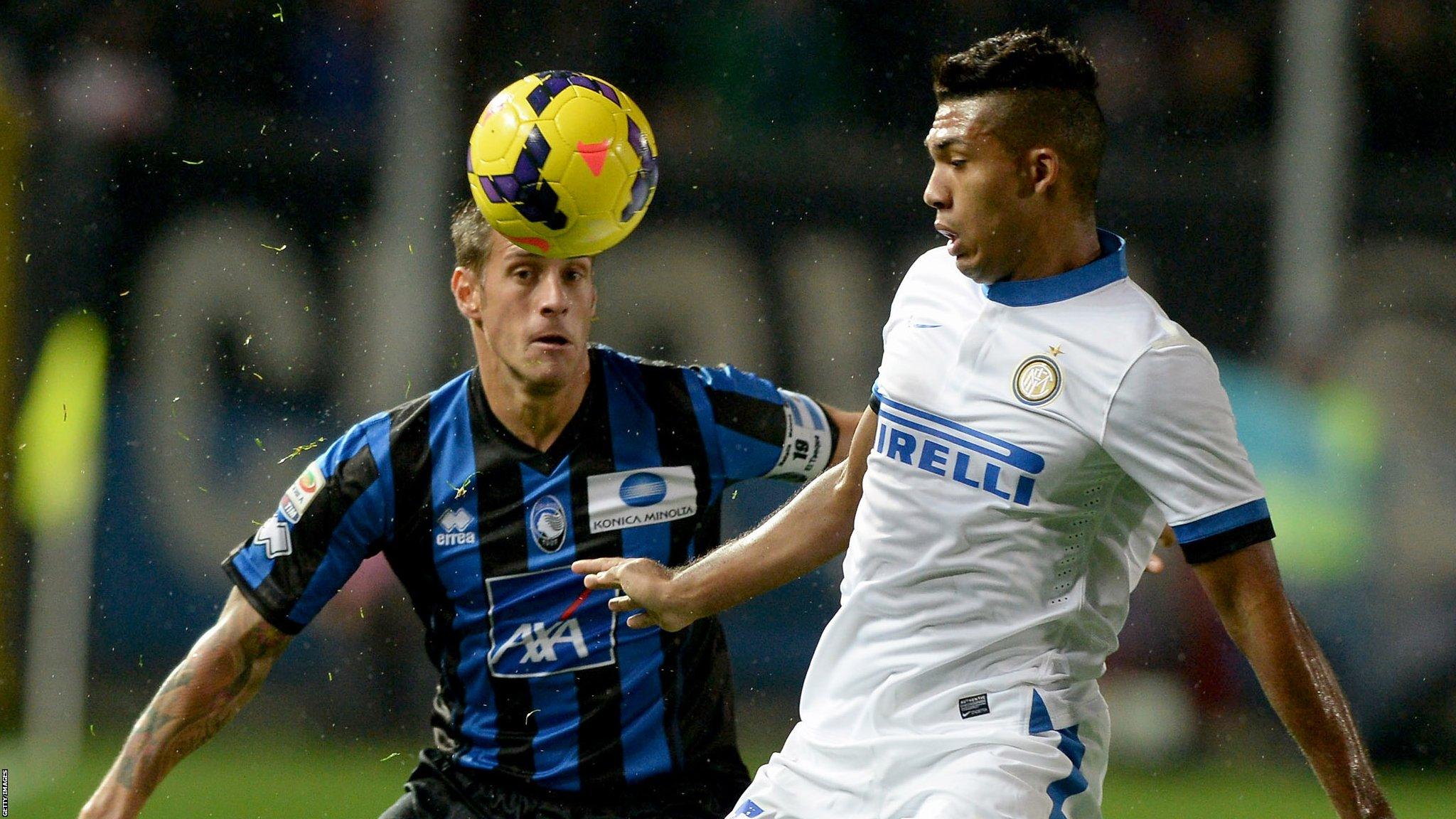 Atalanta's German Denis, left, challenges Atalanta BC and Juan Jesus of Inter Milan.