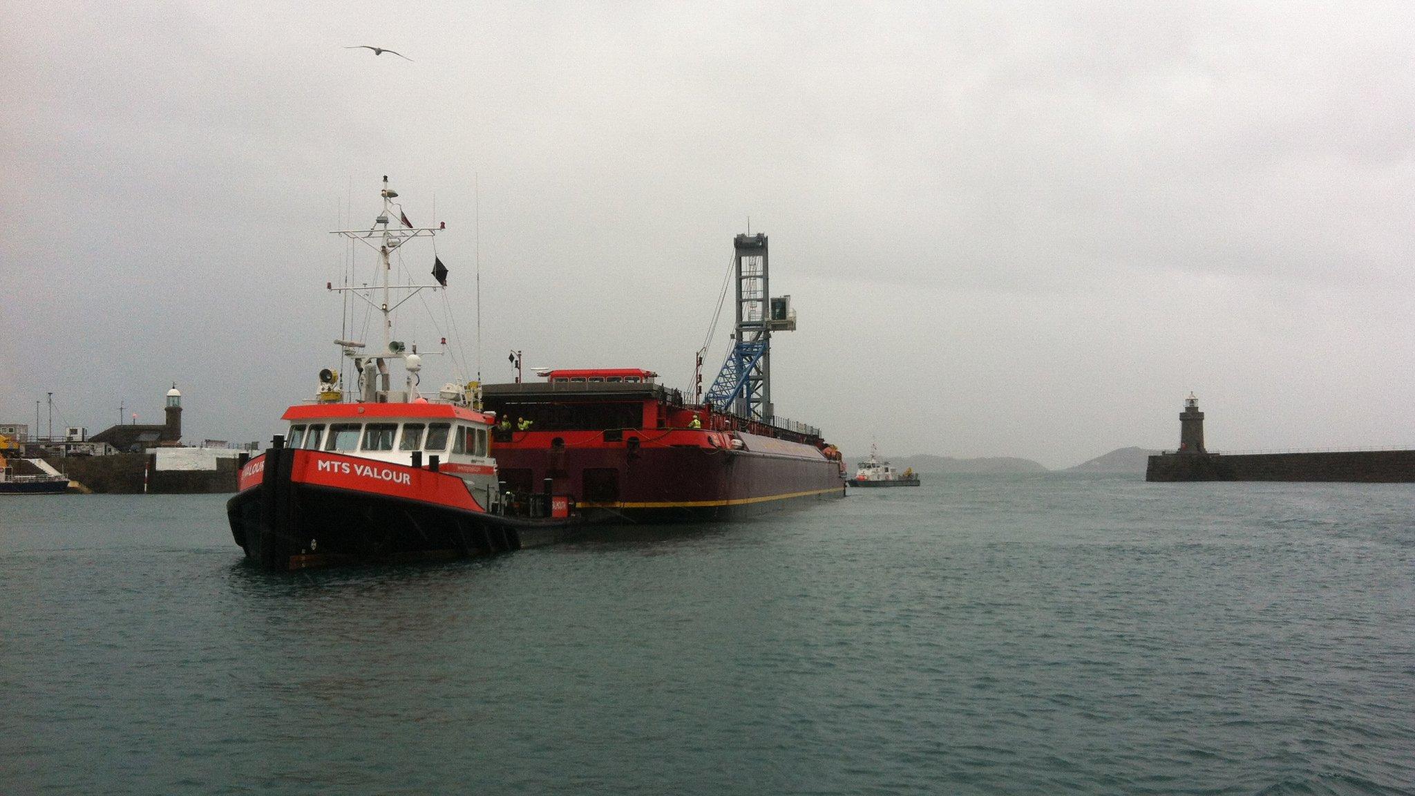 Mobile crane on barge entering Guernsey's St Peter Port Harbour