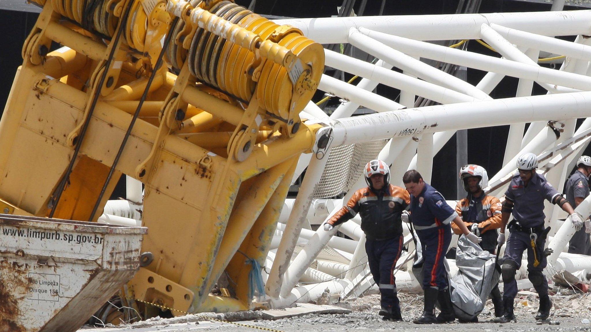 Firefighters recover the body of a worker who was killed when a part of the Itaquerao stadium collapsed, in Sao Paulo, Brazil