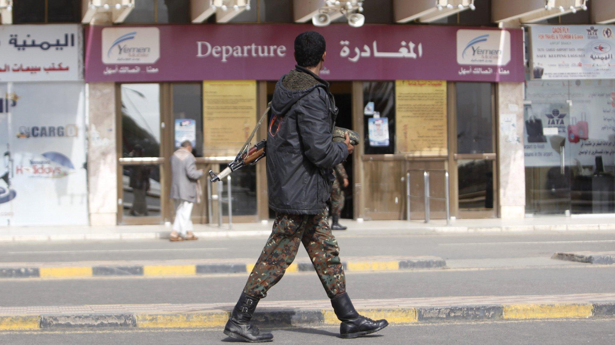 A police trooper walks outside the departure lounge Sanaa International Airport on 7 August 2013