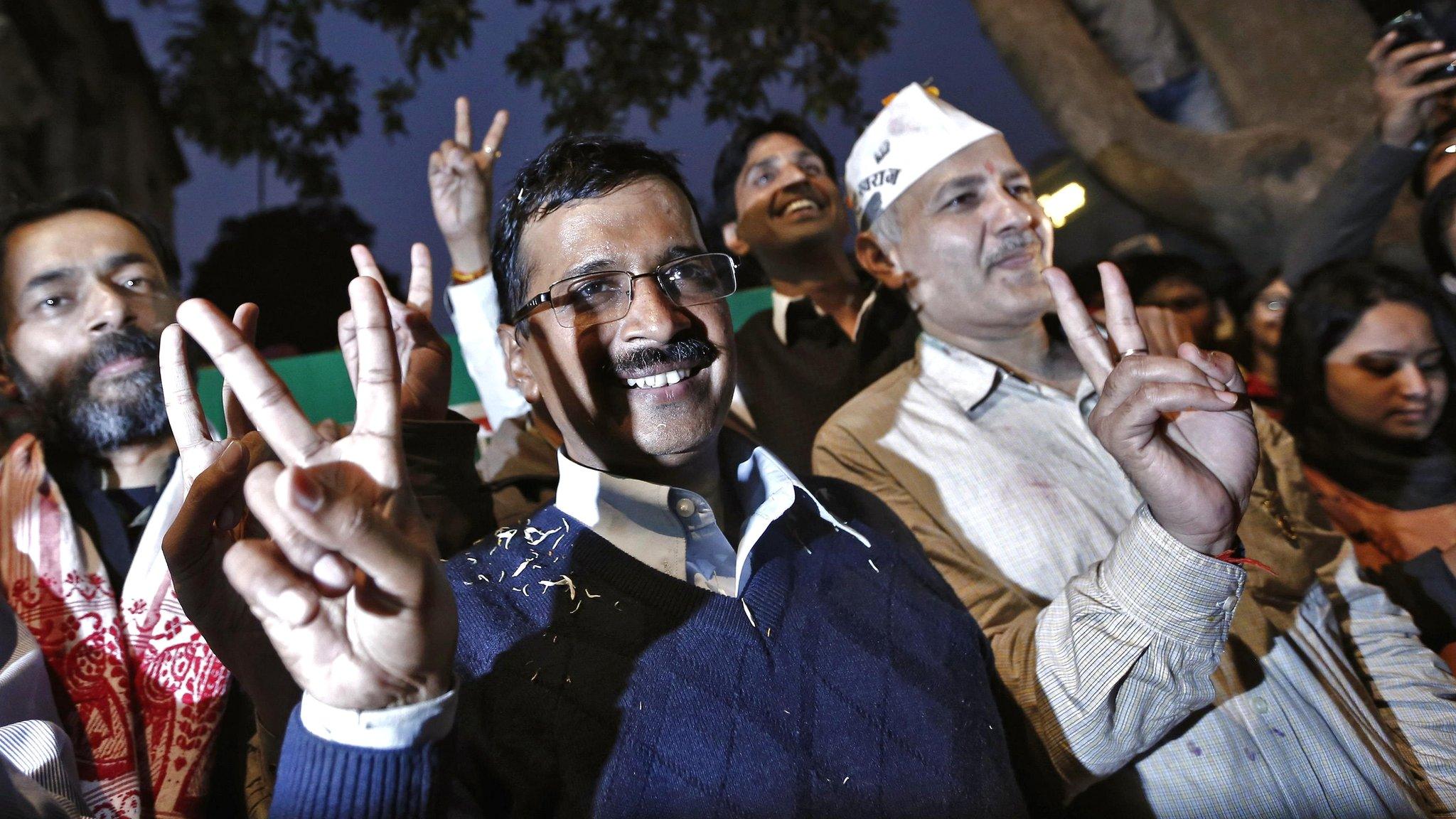 Arvind Kejriwal (C), leader of the Aam Aadmi Party, at his party office in Delhi