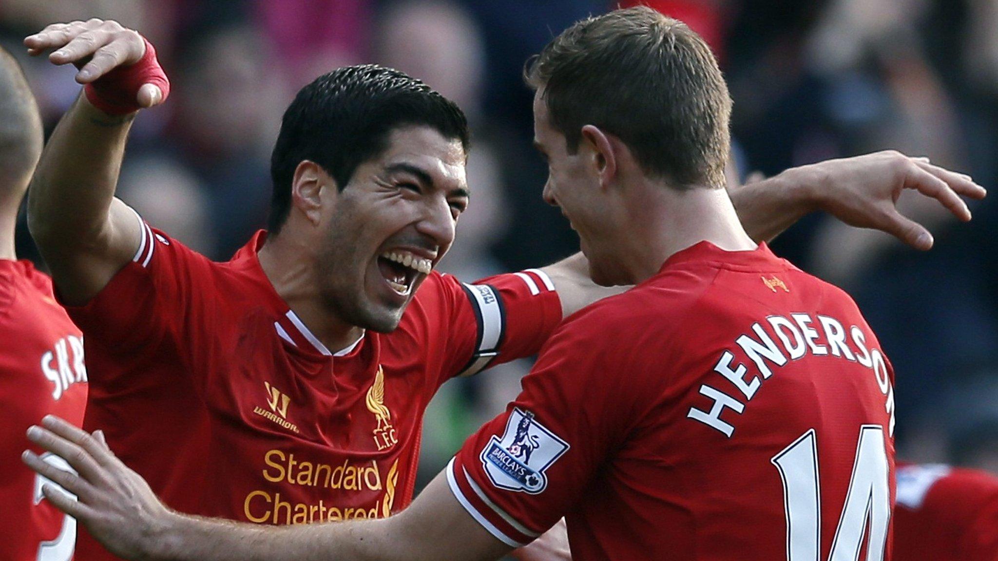 Liverpool striker Luis Suarez (left) and team-mate Jordon Henderson celebrate during the win over Cardiff