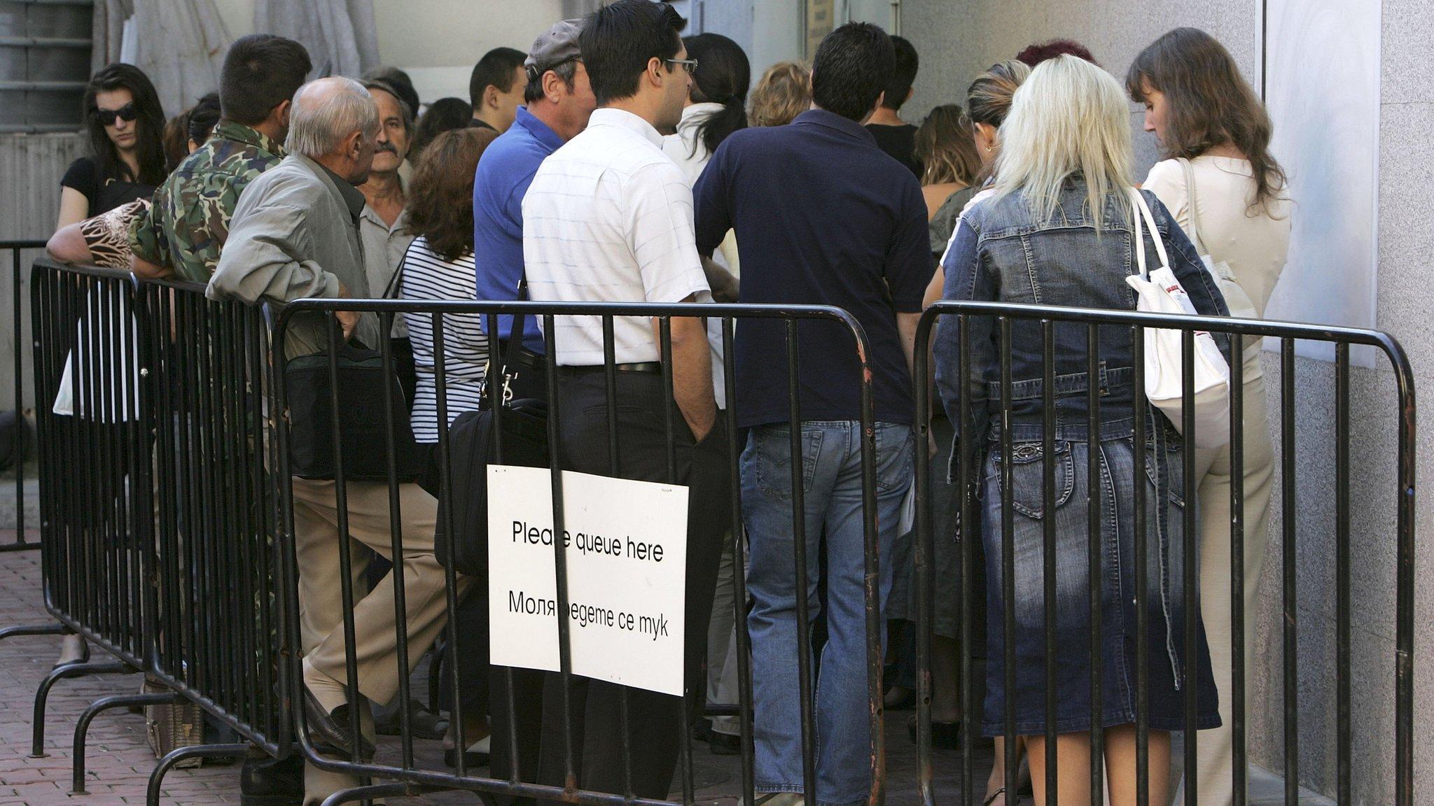 Bulgarians queue outside the British Embassy in Sofia to apply for visas to work in the UK