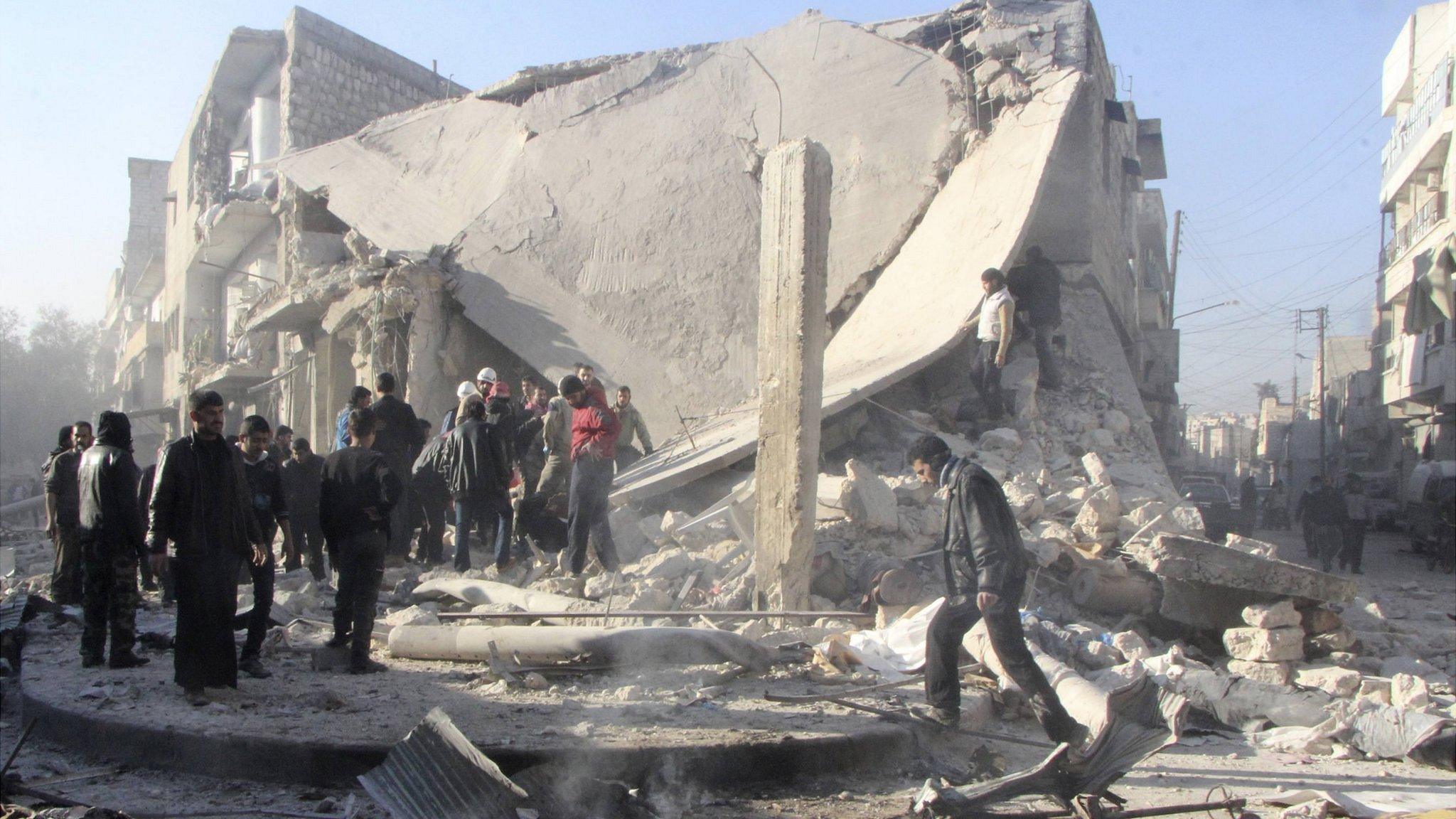 Syrians inspect a damaged building