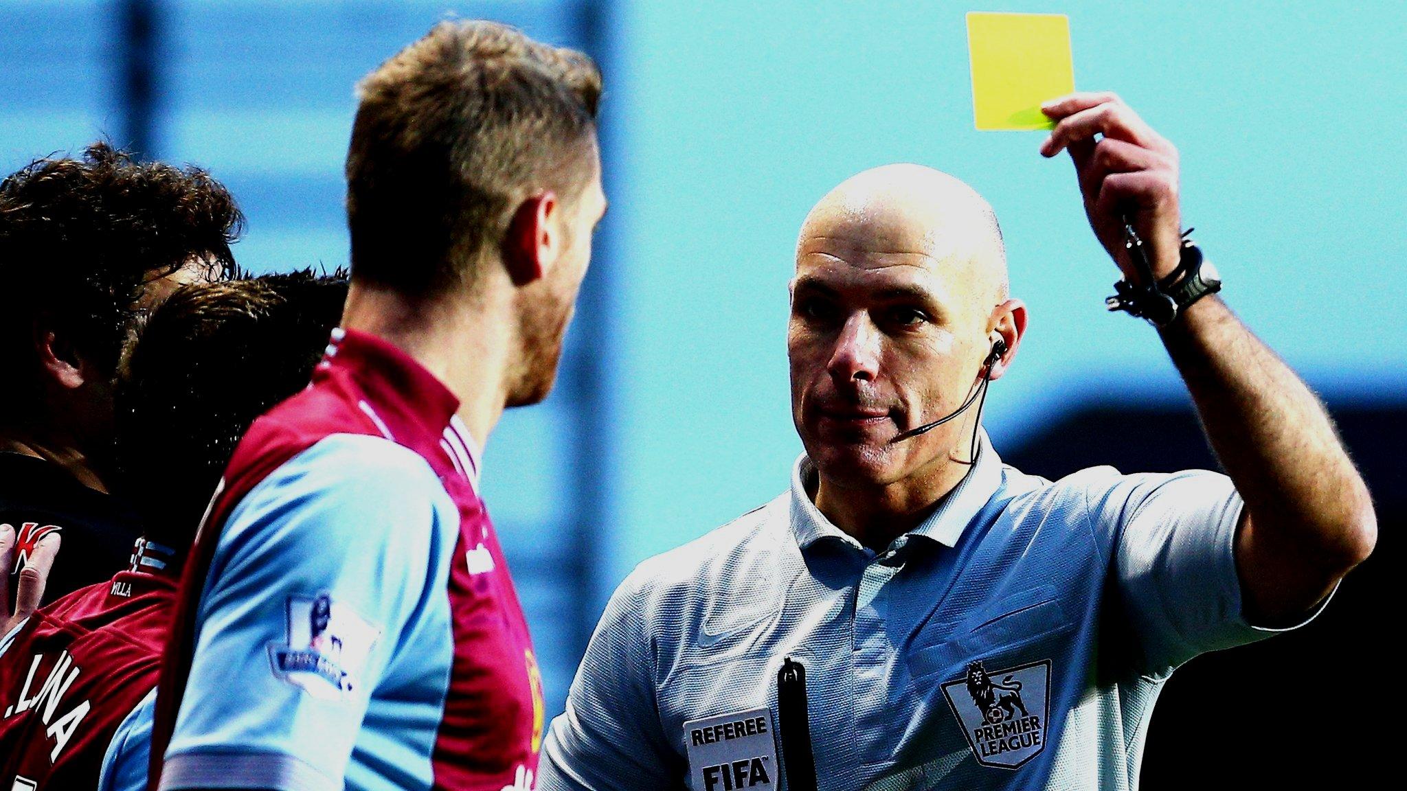 Howard Webb cautions a West Ham player