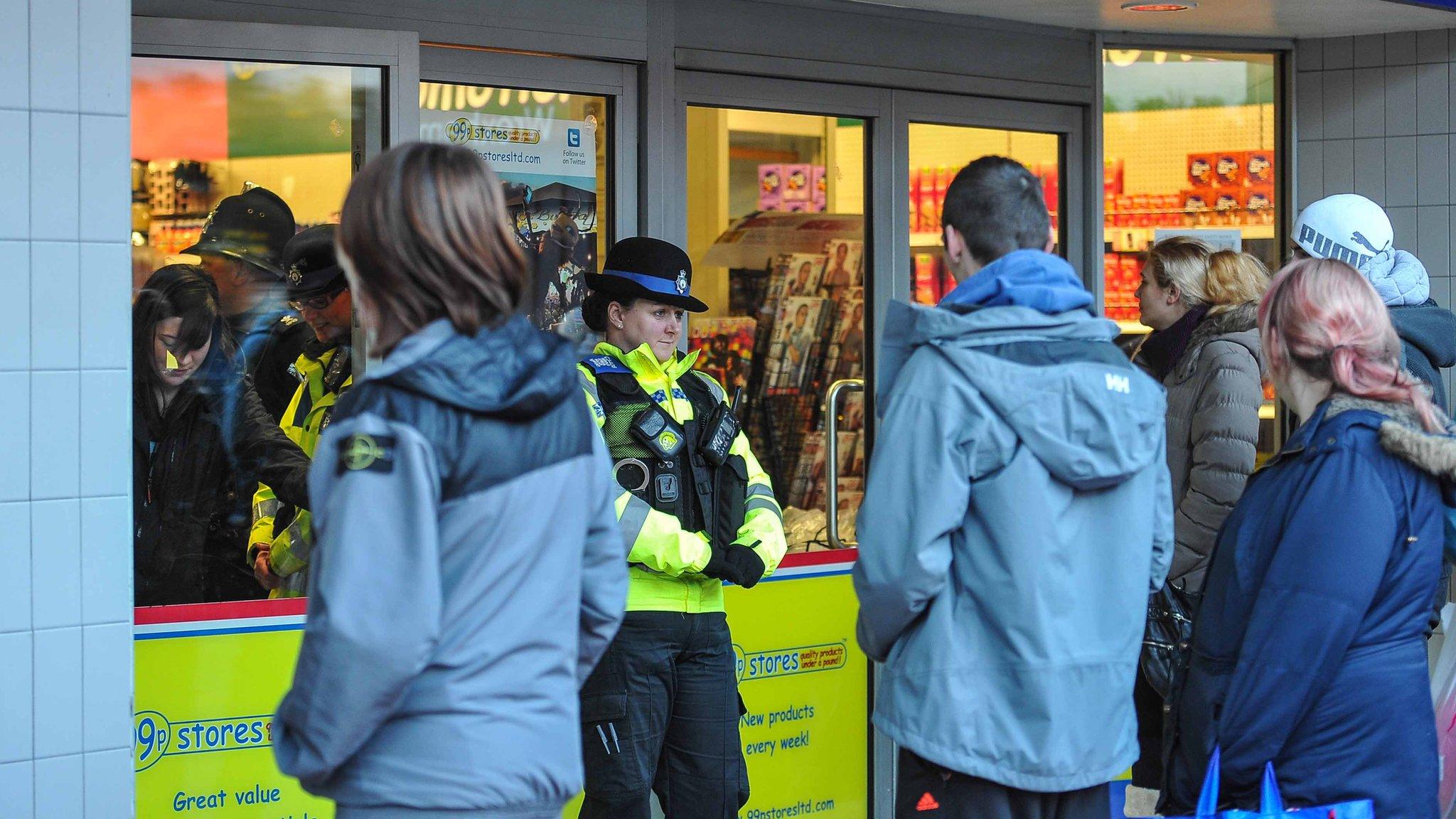 Police officers at the 99p Stores in Wrexham