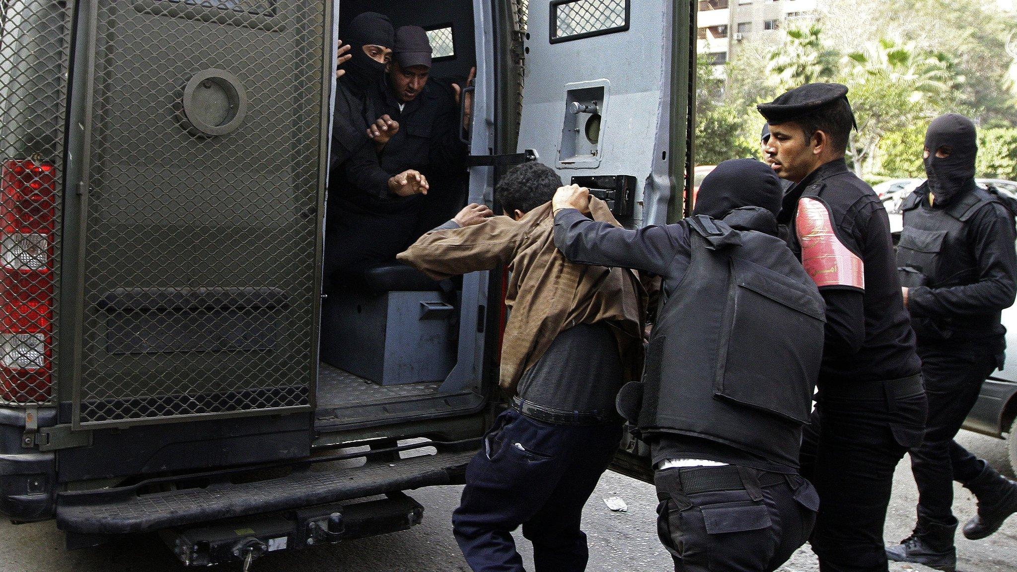 Man detained by police during clashes with pro-Morsi supporters in Nasr City, Cairo, on 17 January 2014