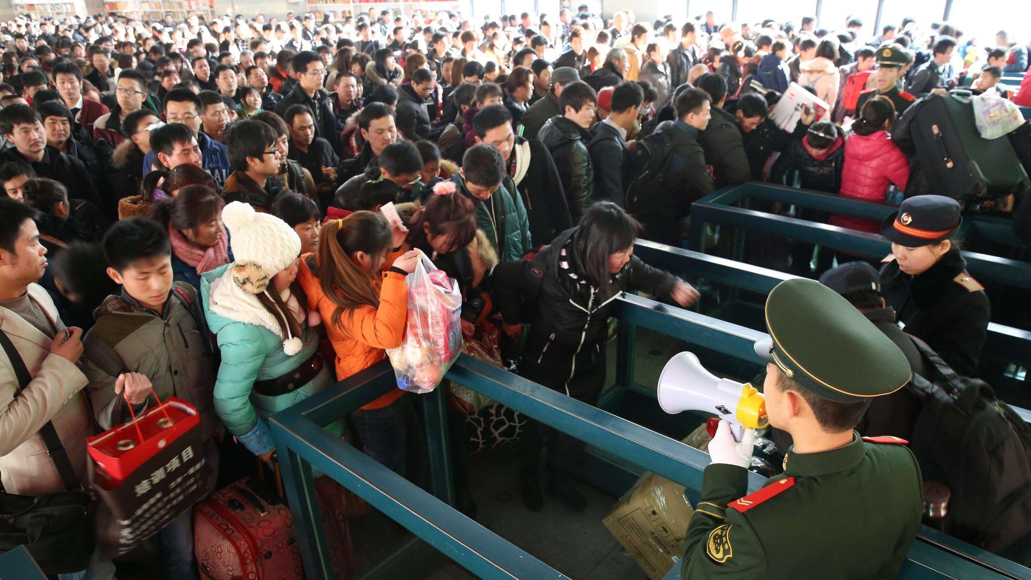 Passengers wait for trains at Beijing West Railway Station on 26 January 2014