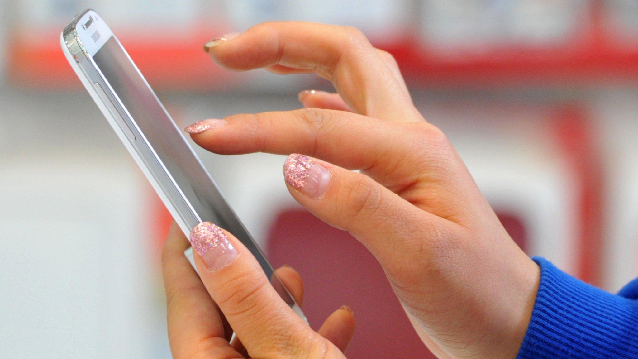 A woman using a Samsung smartphone