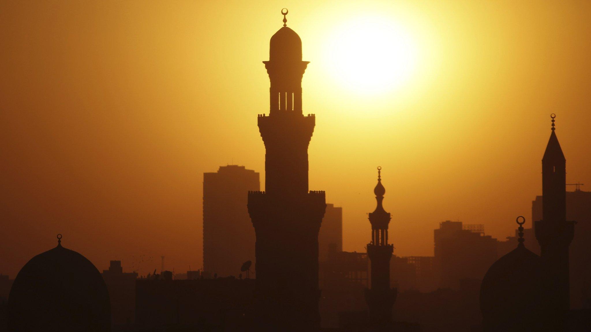 The sun sets over the minarets of mosques on the 12th day of the holy fasting month of Ramadan, in Old Cairo (July 21, 2013)