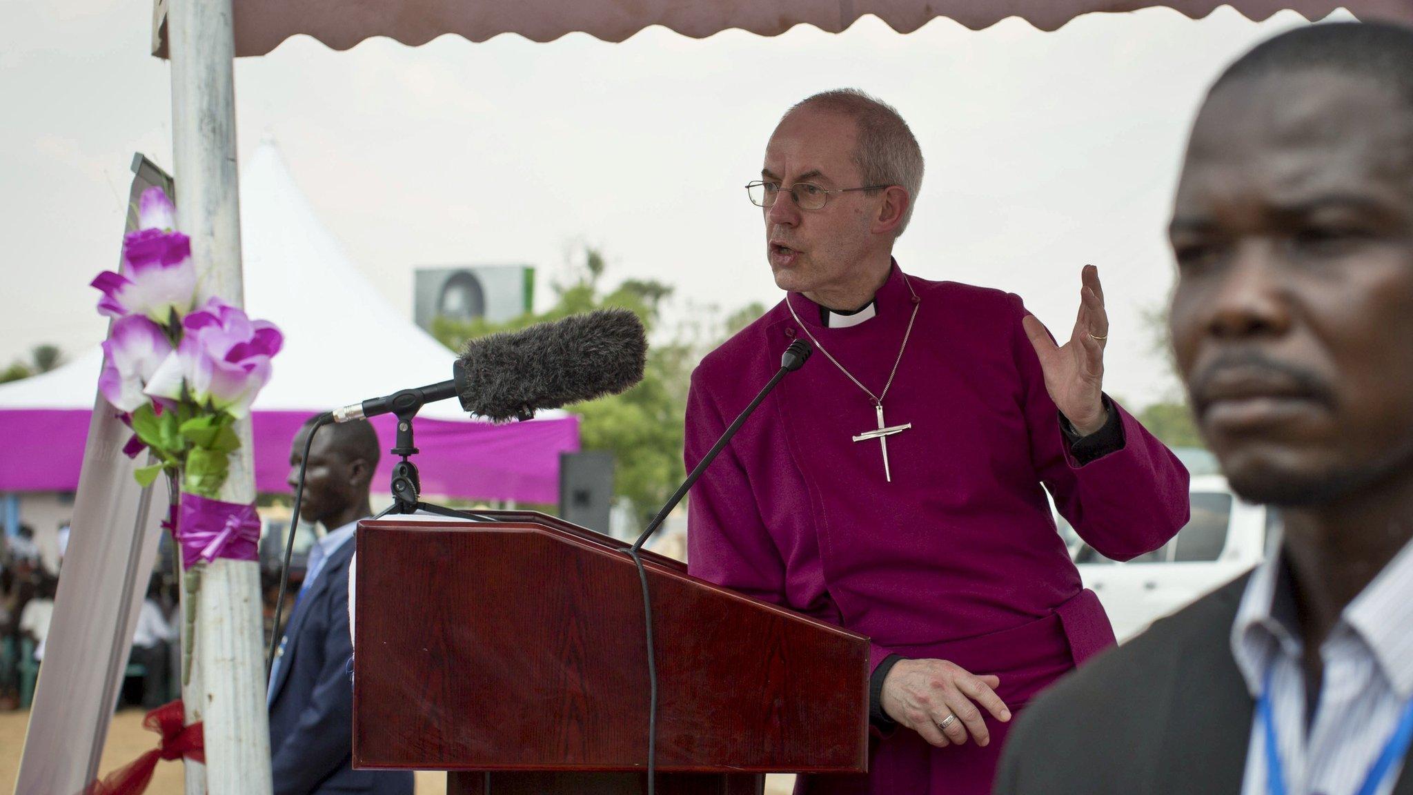 The Archbishop of Canterbury Justin Welby speaks to the local congregation outside a church in Juba, South Sudan Thursday, Jan. 30, 2014