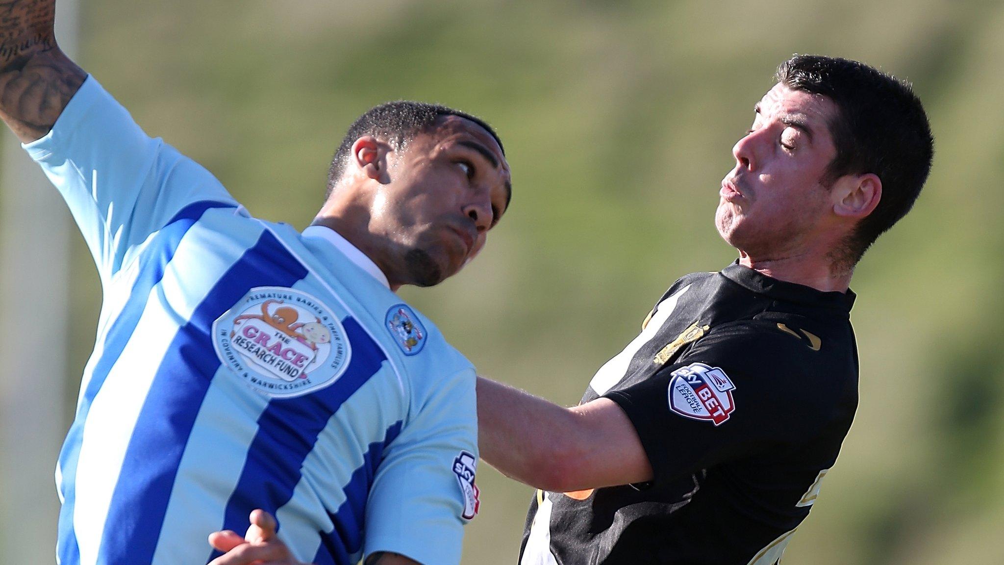 Callum Wilson challenges Port Vale's Richard Duffy