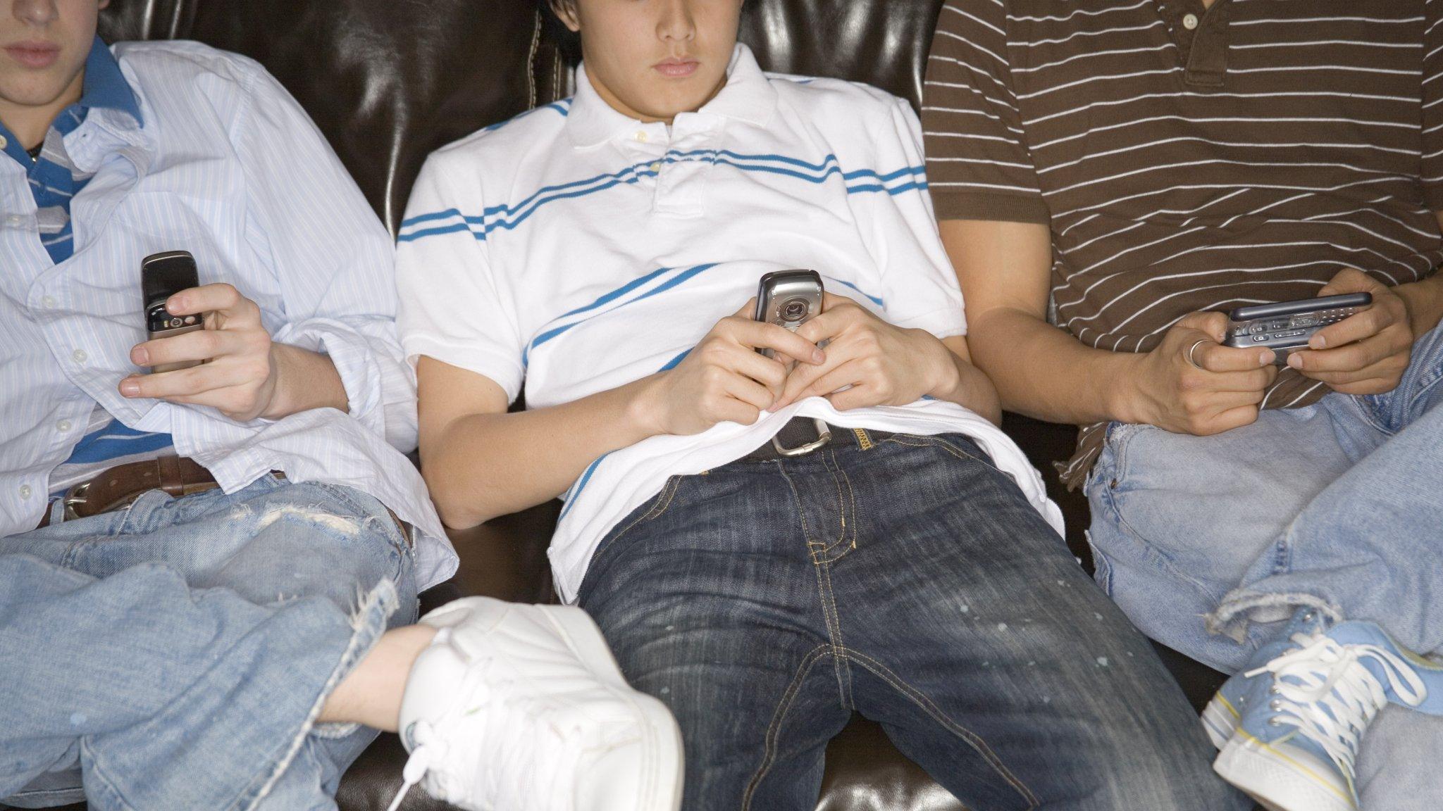 Teenagers using mobile phones