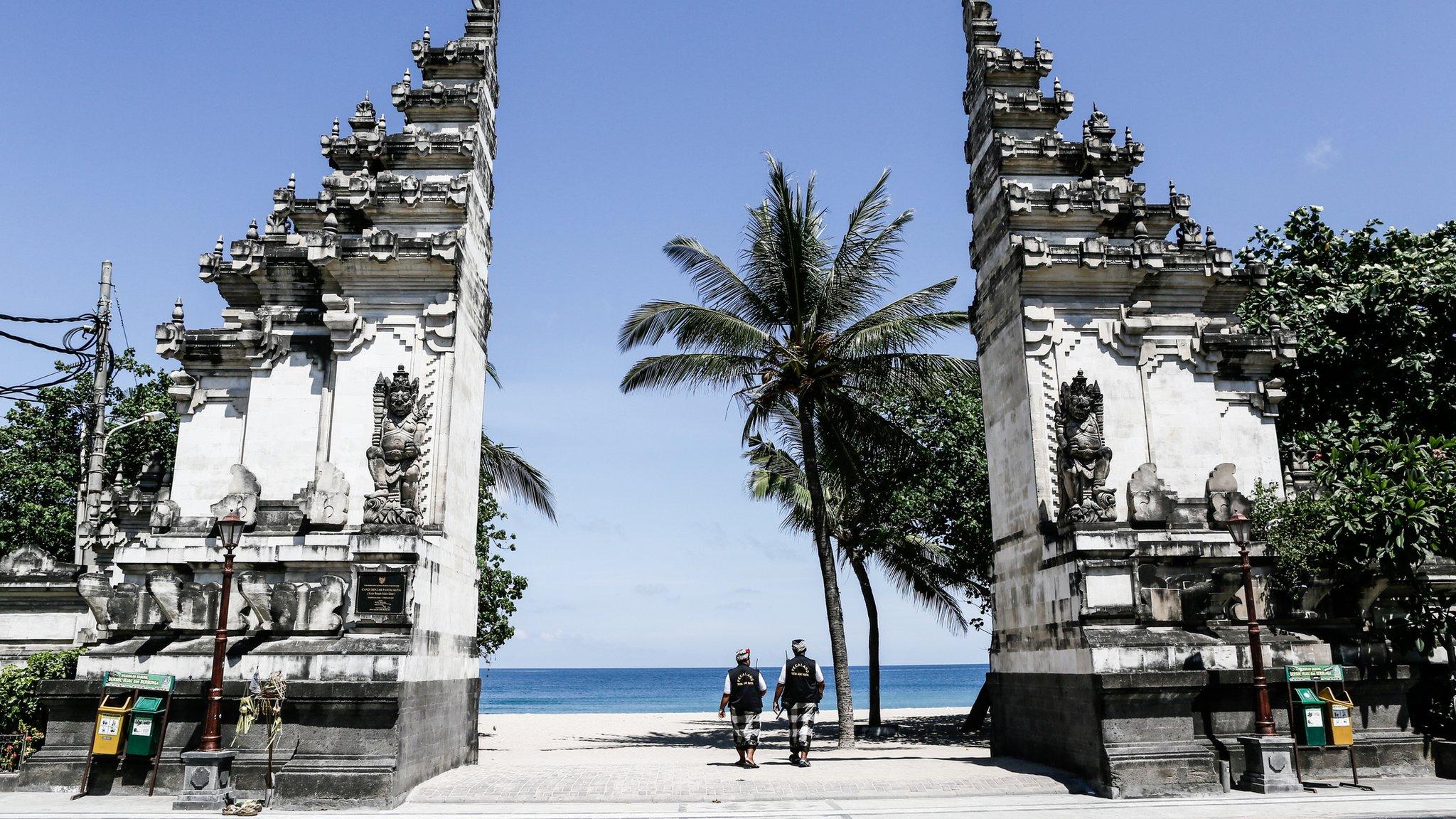 An empty street patrolled by traditional guards on Nyepi in Bali